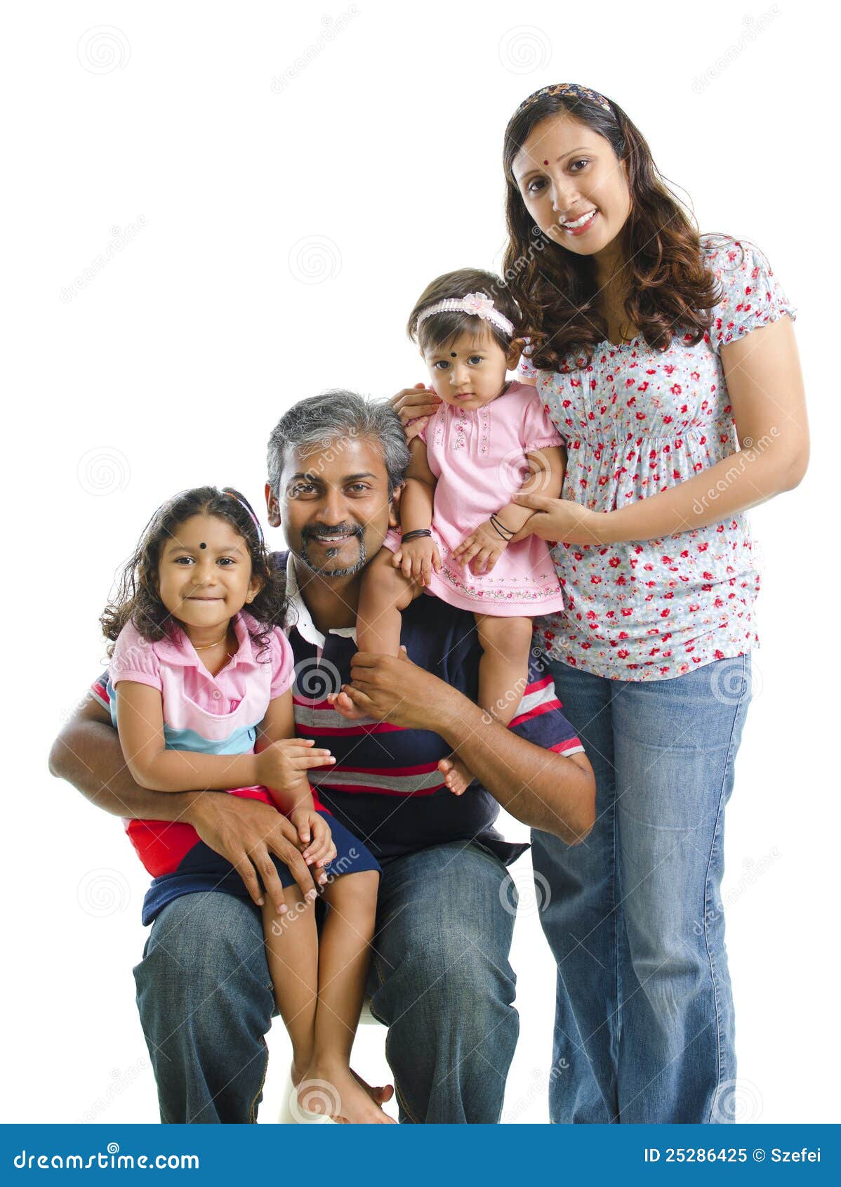 Premium Photo | An indian family poses for a portrait in front of a blue  background