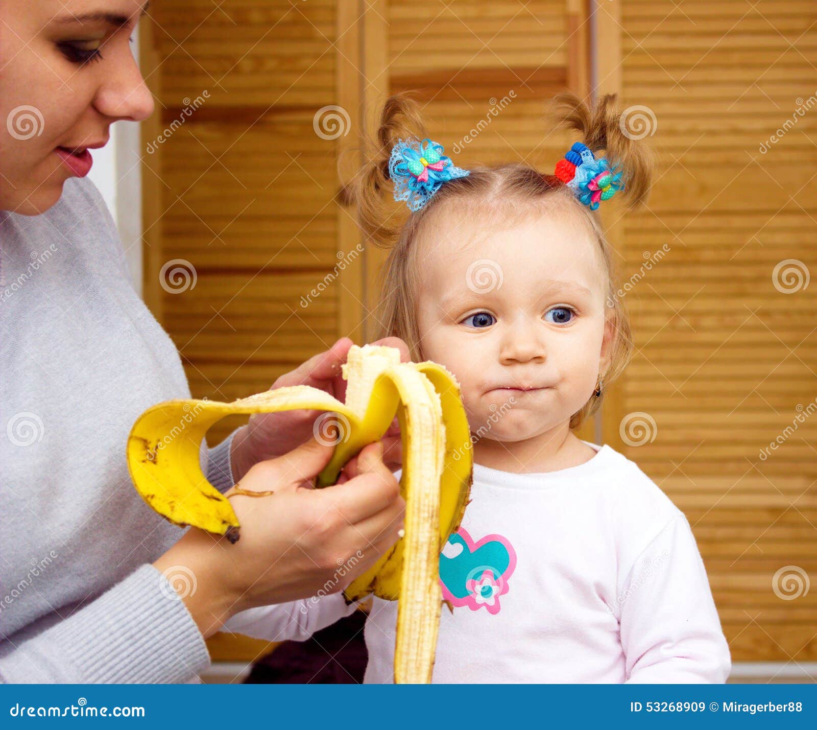 Happy Mom and Baby Girl Eating Banan. the Concept of Childhood and ...