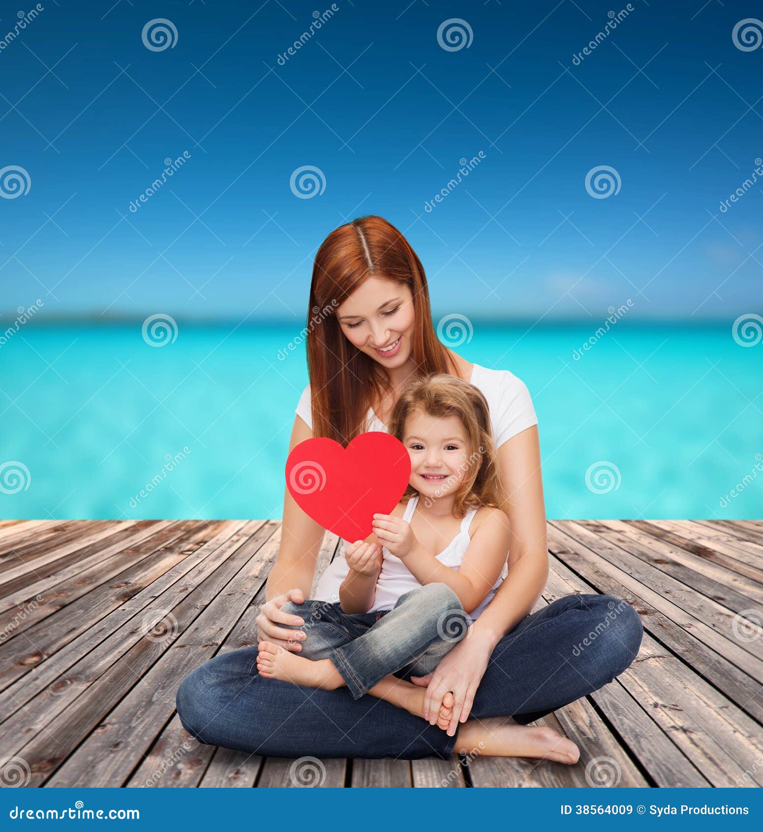 Happy mother with adorable little girl and heart. Childhood, parenting and relationship concept - happy mother with adorable little girl and red heart