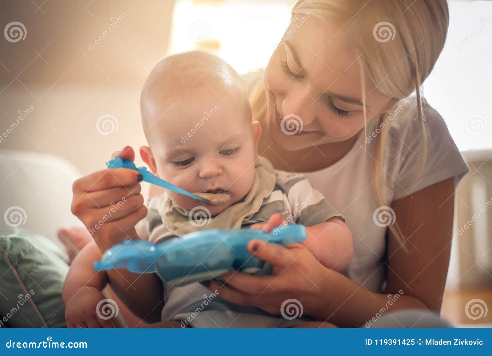 Mother Feeding Child. Image & Photo (Free Trial)