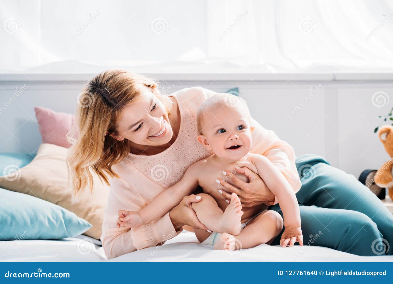 Happy Mother and Child Relaxing on Bed Stock Photo - Image of mommy ...