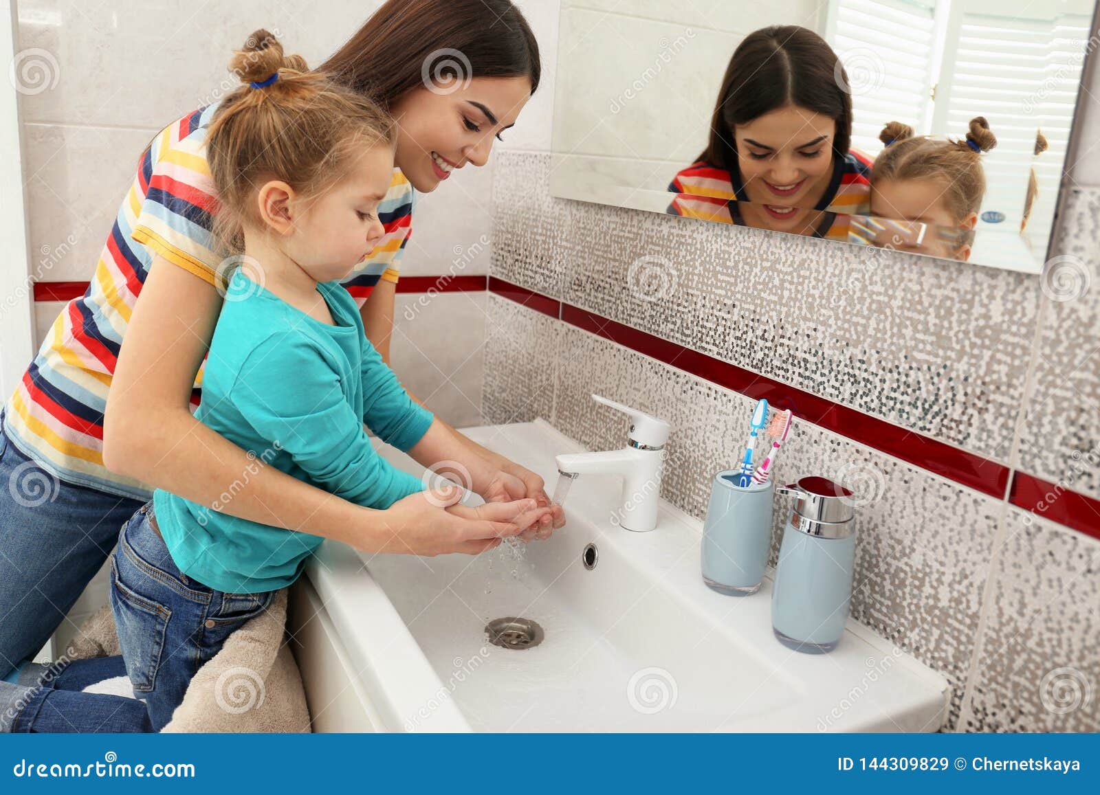 Happy Mother And Daughter Washing Hands In Bathroom Stock ...