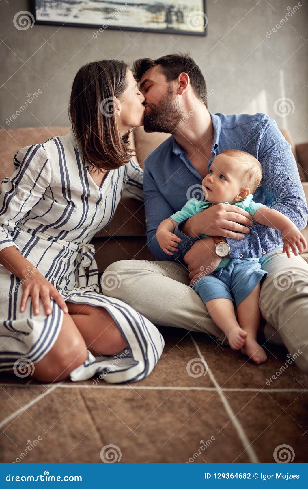 Happy Mother and Father Holding Their Baby Boy and Kissing at Ho ...