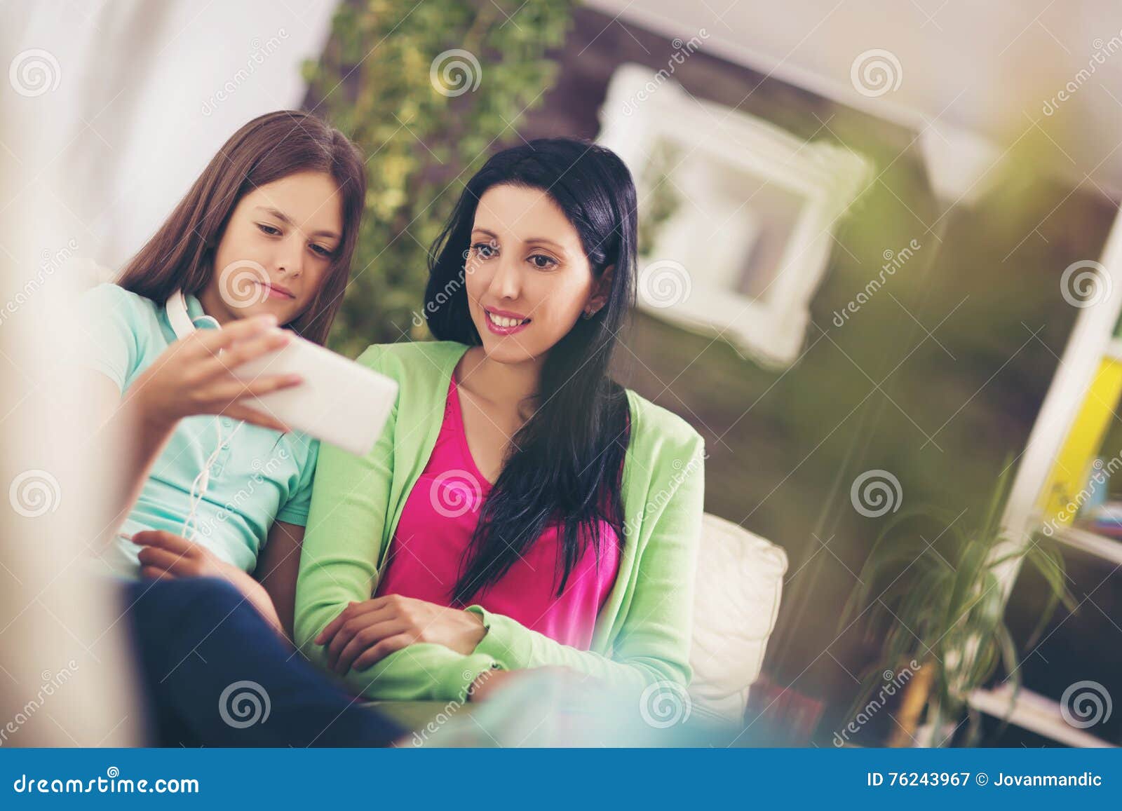 Happy Mother And Her Cute Teen Daughter Are Looking At Mobile Phone Stock Image Image Of