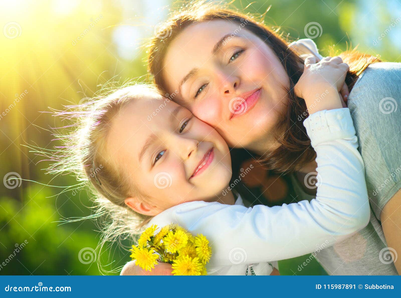 happy mother and her little daughter outdoor. mom and daughter enjoying nature together in green park