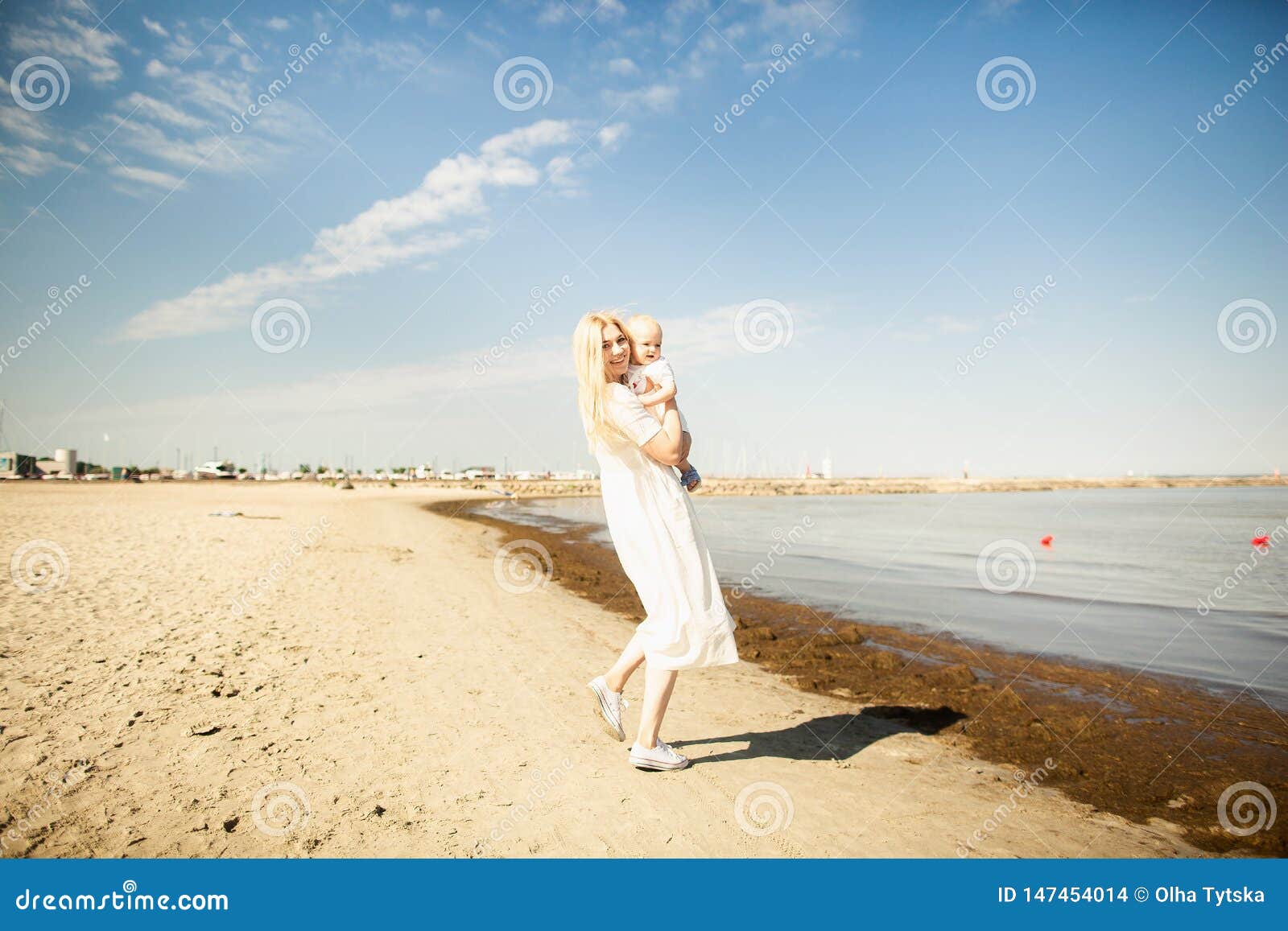 happy mother huges baby. mother holds child in her arms, baby hugging mom