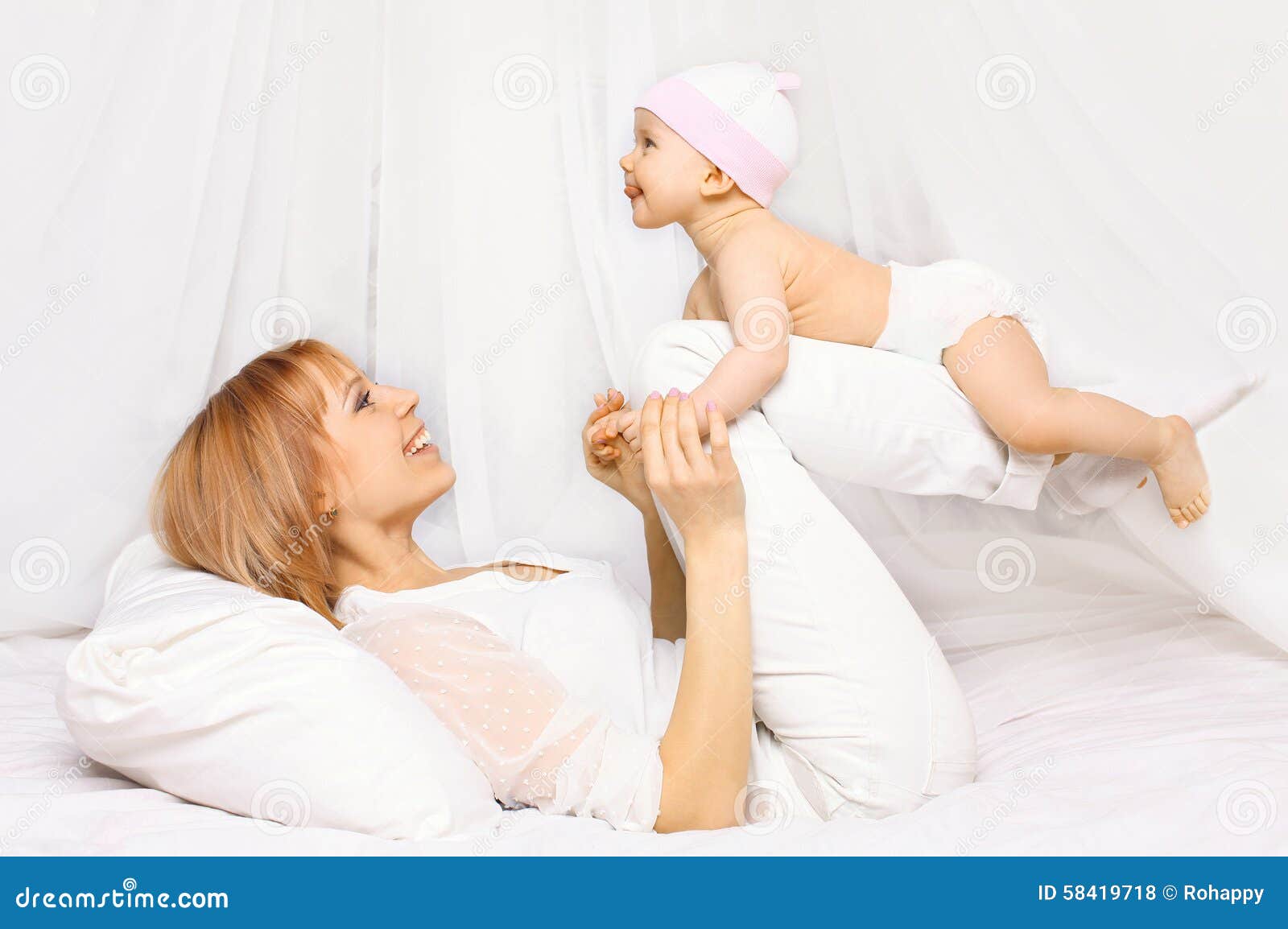 Happy Mother Playing with Baby Having Fun Together on the Bed Stock ...