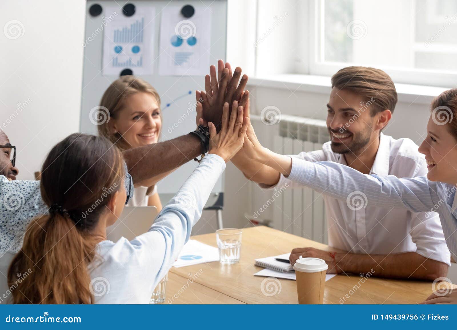Happy Motivated Diverse Members of Business Team Join Hands Together