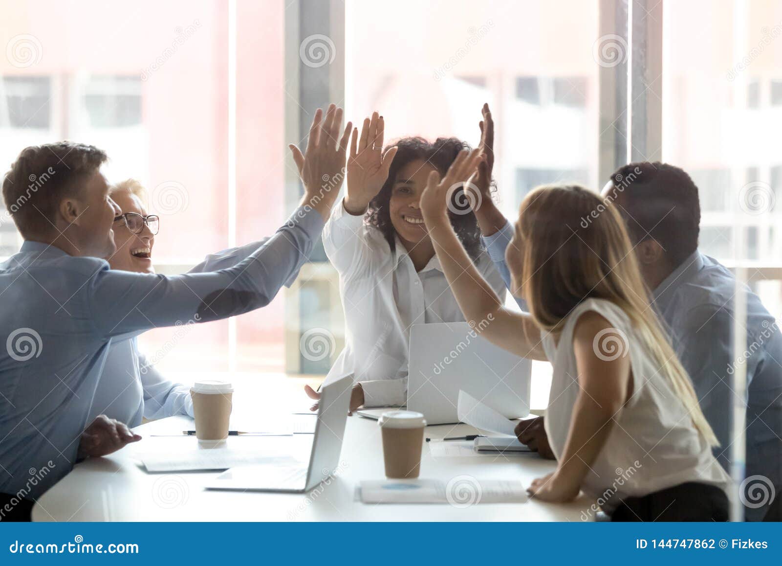 happy multicultural executive team people give high five celebrate success