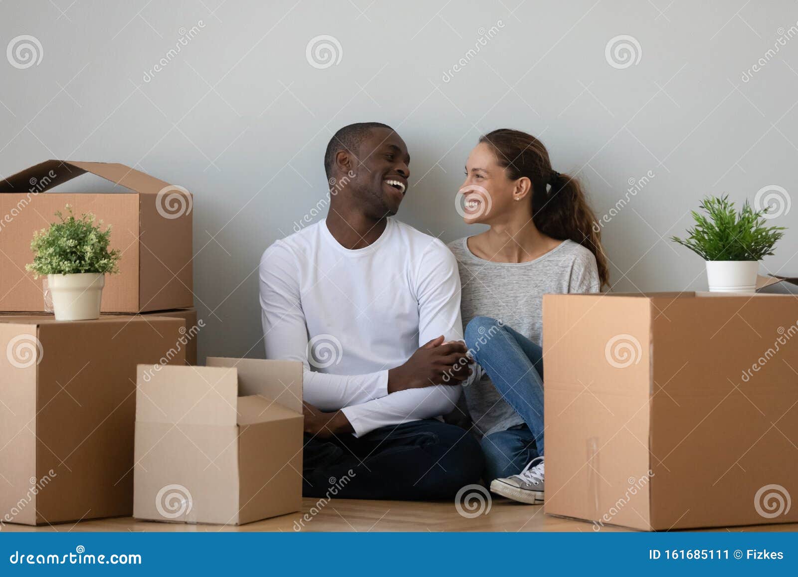 happy multiethnic couple moving to new home together