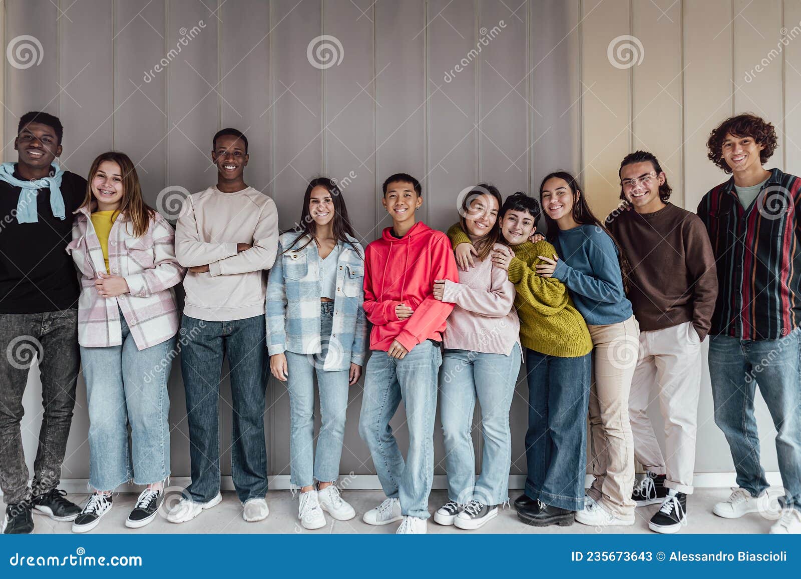 happy multiracial group of teenagers having fun inside university