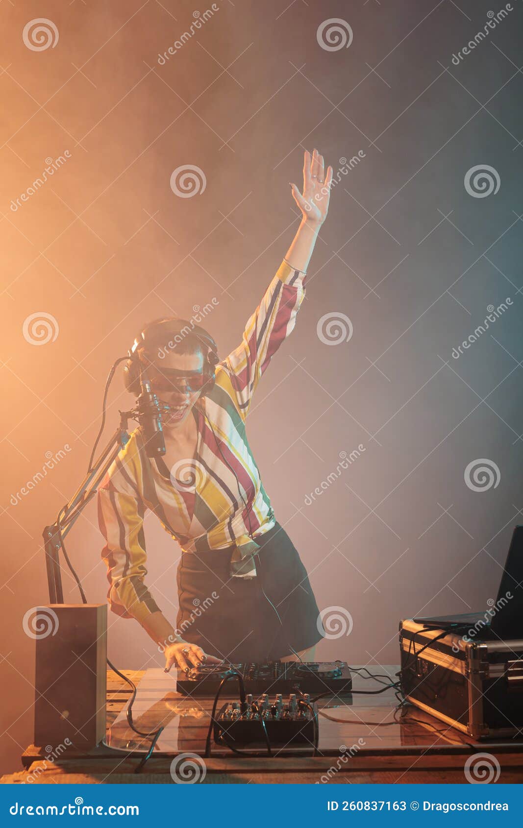 happy musical artist using mixer to play techno