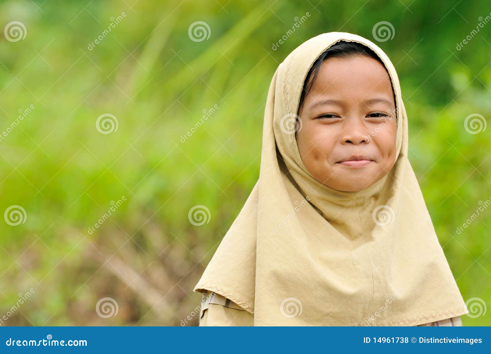 Happy Muslim Girl. Muslim little schoolgirl on the way home. Indonesia.