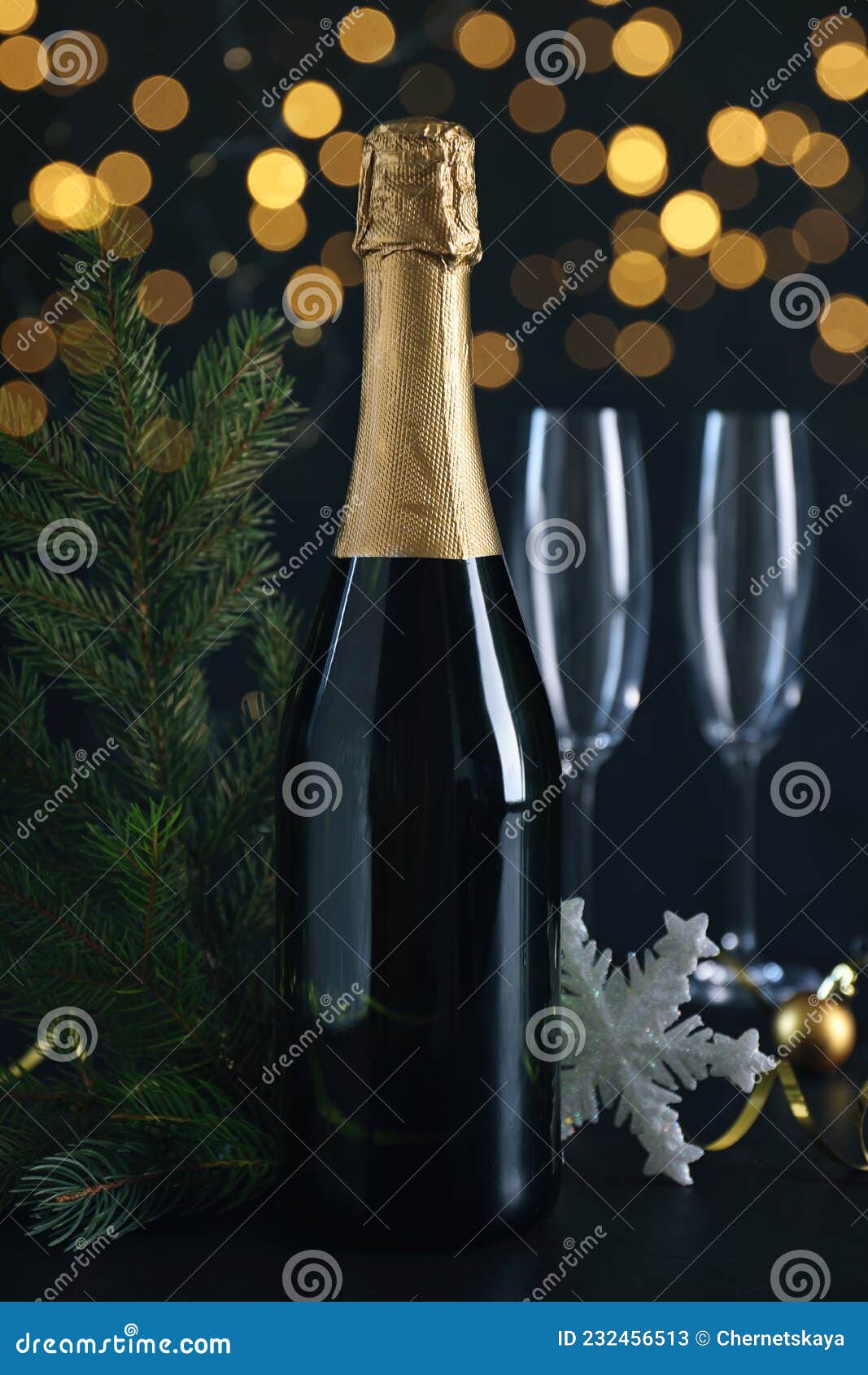 Happy New Year! Bottle of Sparkling Wine, Glasses and Festive Decor on