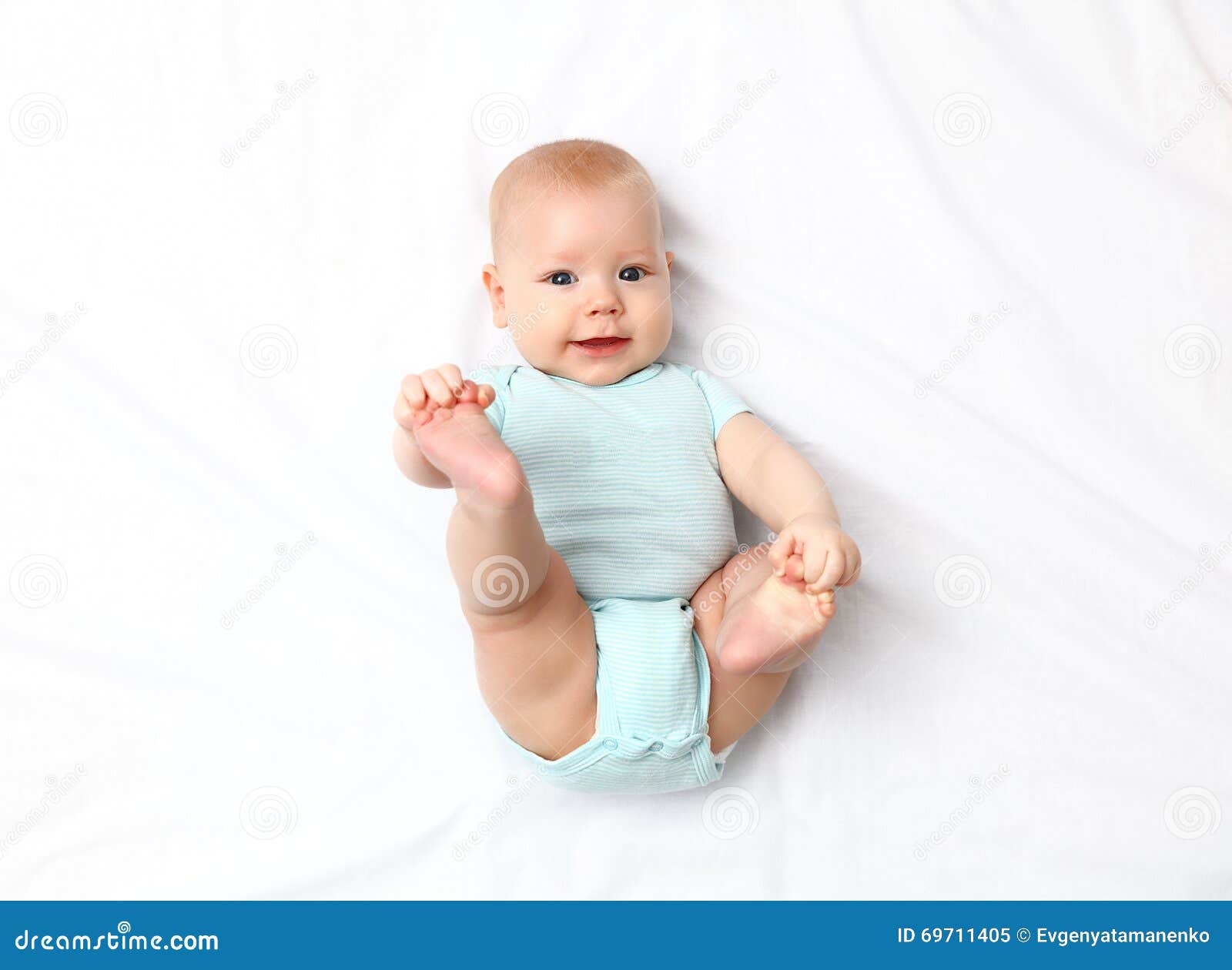 Happy newborn baby on bed stock image. Image of cheerful 69711405