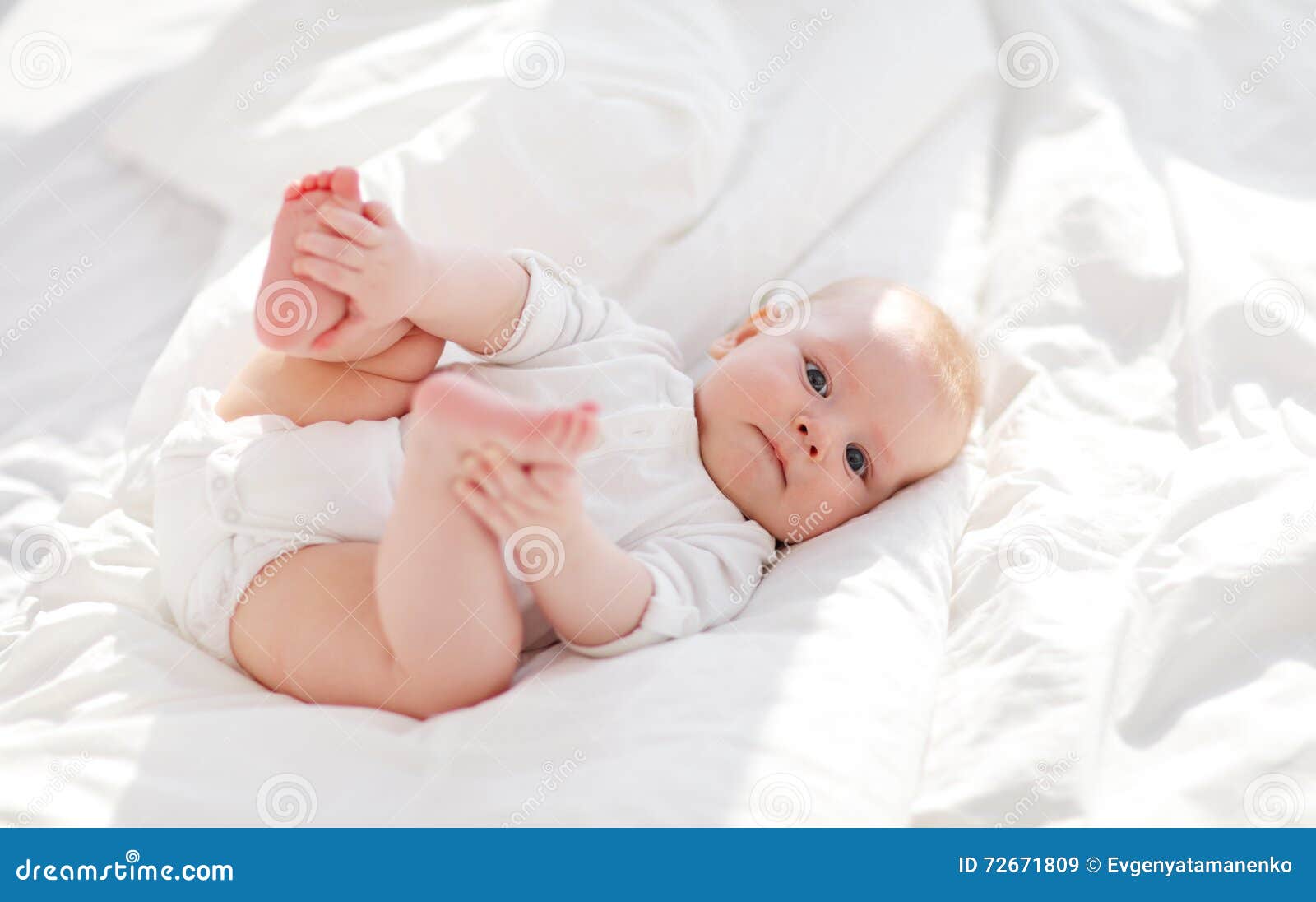 Happy newborn baby on bed stock image. Image of beautiful 72671809