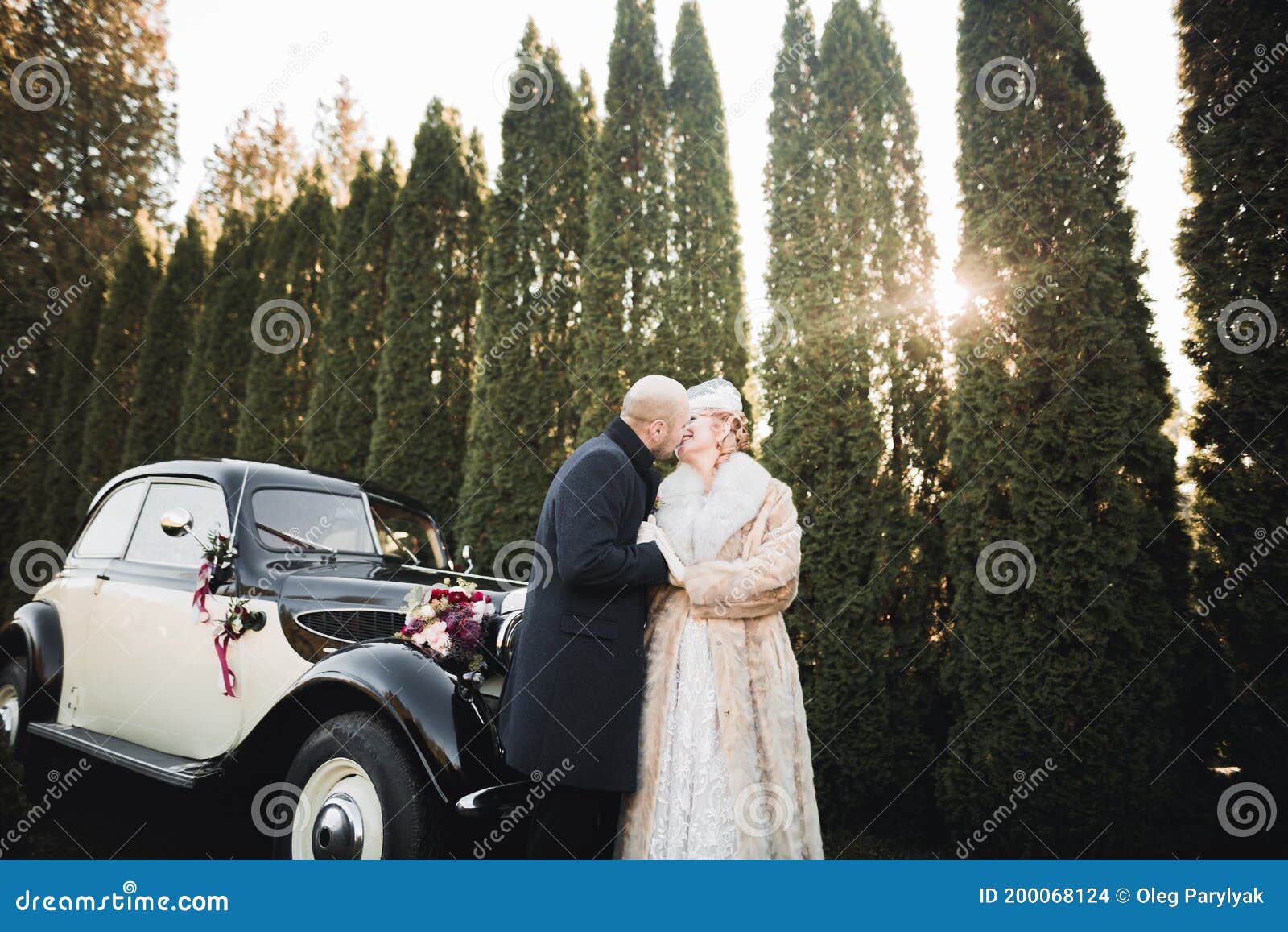 Happy Newlywed Couple Man And Wife Kissing Near Stylish Retro Car