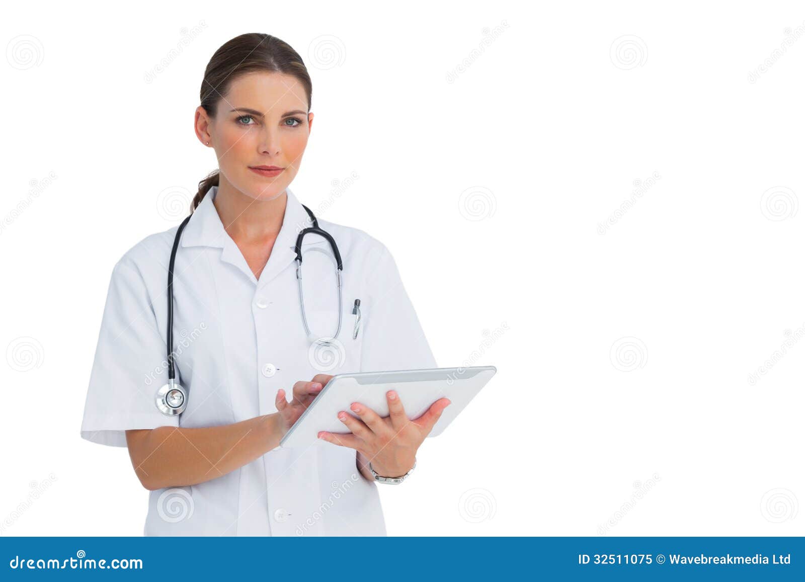 Happy Nurse Working on Her Tablet and Looking at Camera Stock Image
