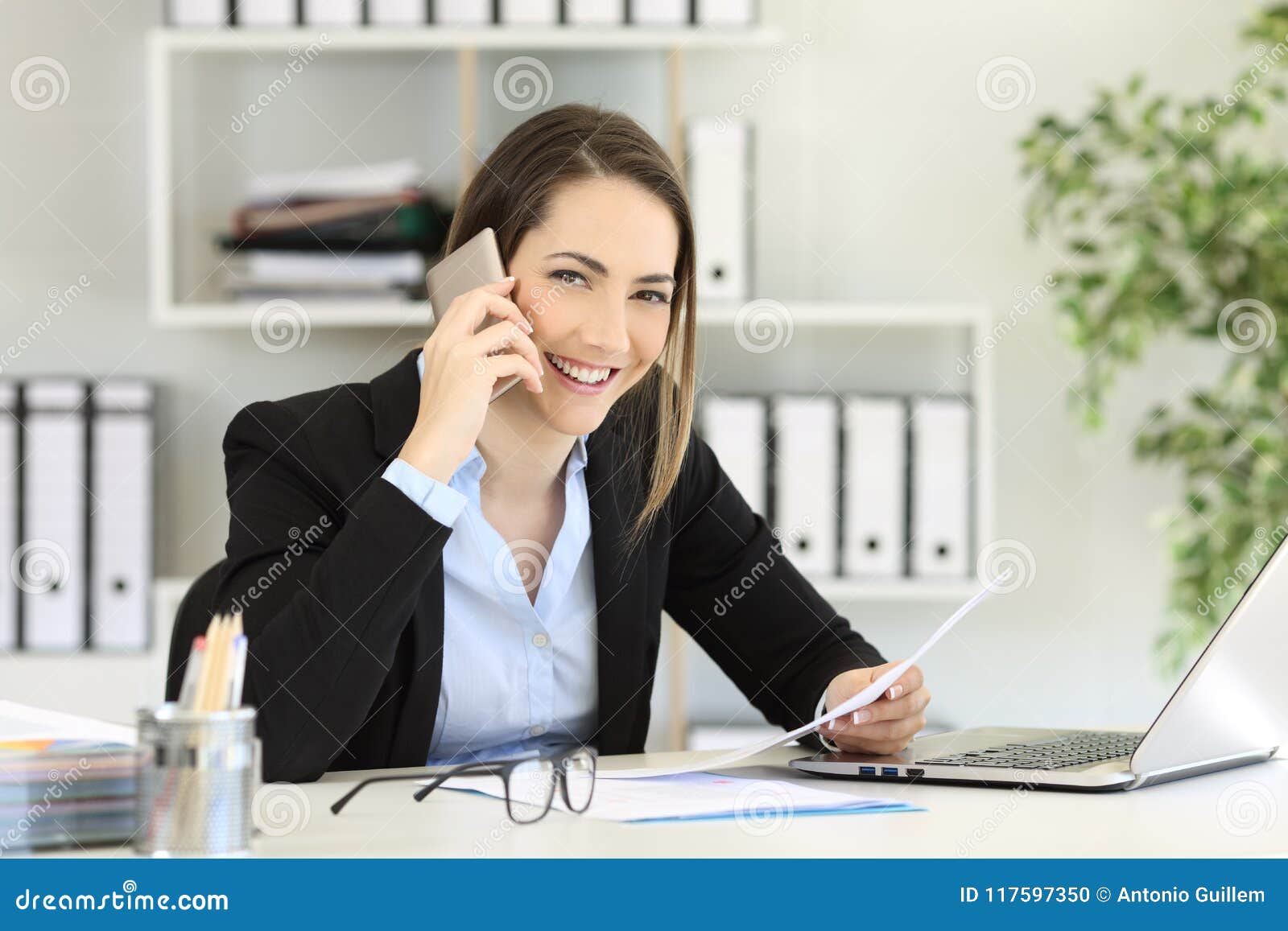 office worker calling on phone looking at you