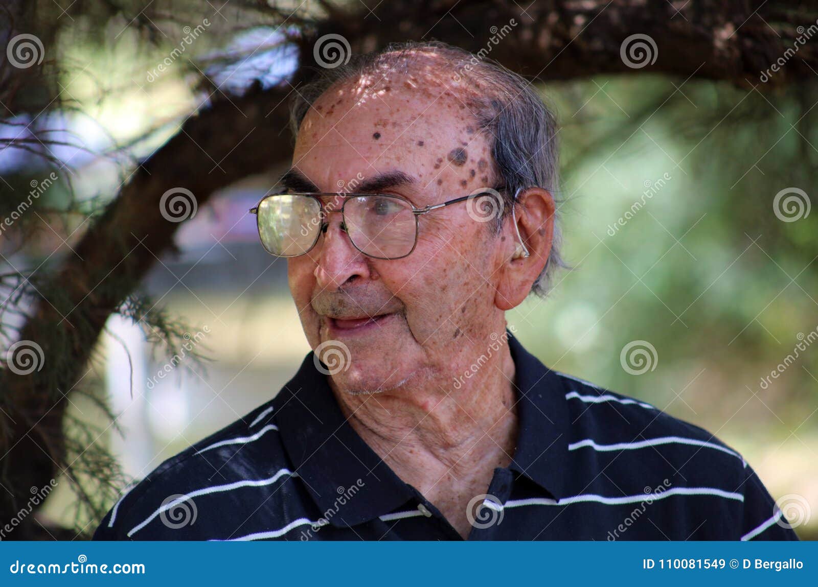 happy old argentine grandfather enjoying life waving hi, with big smile, big glasses and confident abuelo