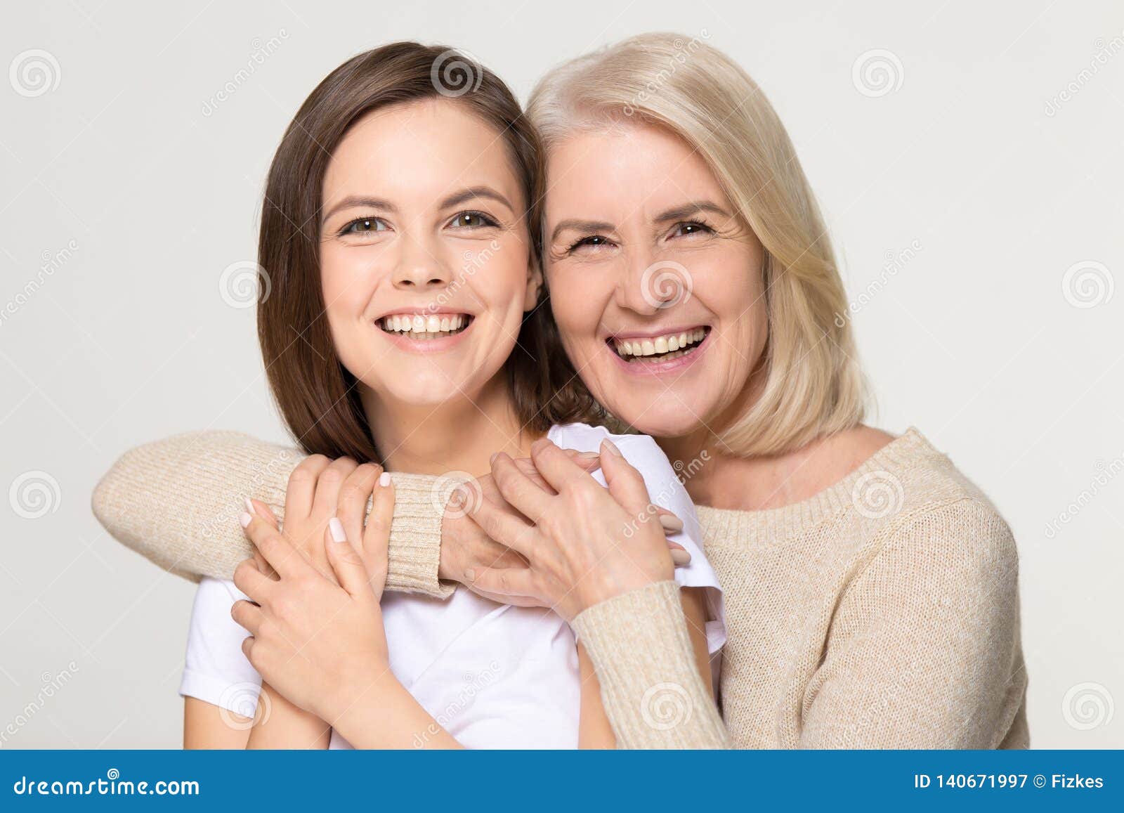 Happy Old Mother Embracing Young Daughter Isolated On Background Stoc