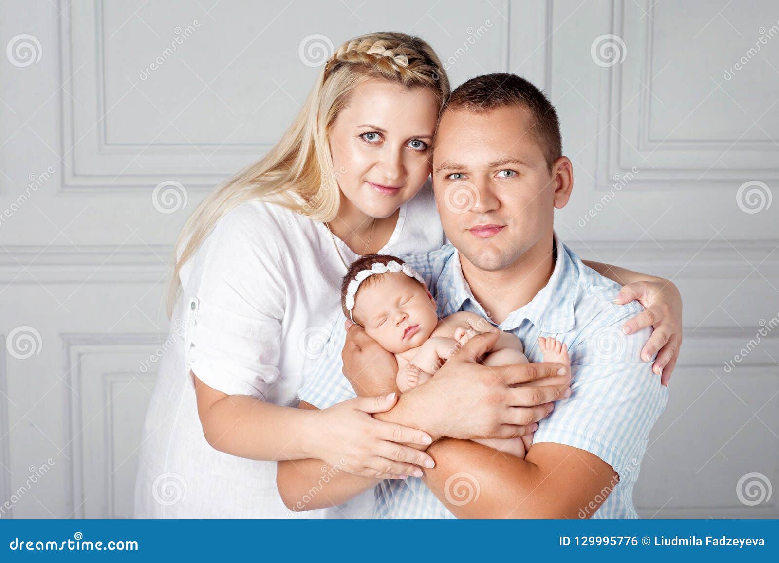 Happy Parents Holding a Cute Newborn Girl. Mom, Dad and Baby Stock Photo -  Image of child, girl: 129995776