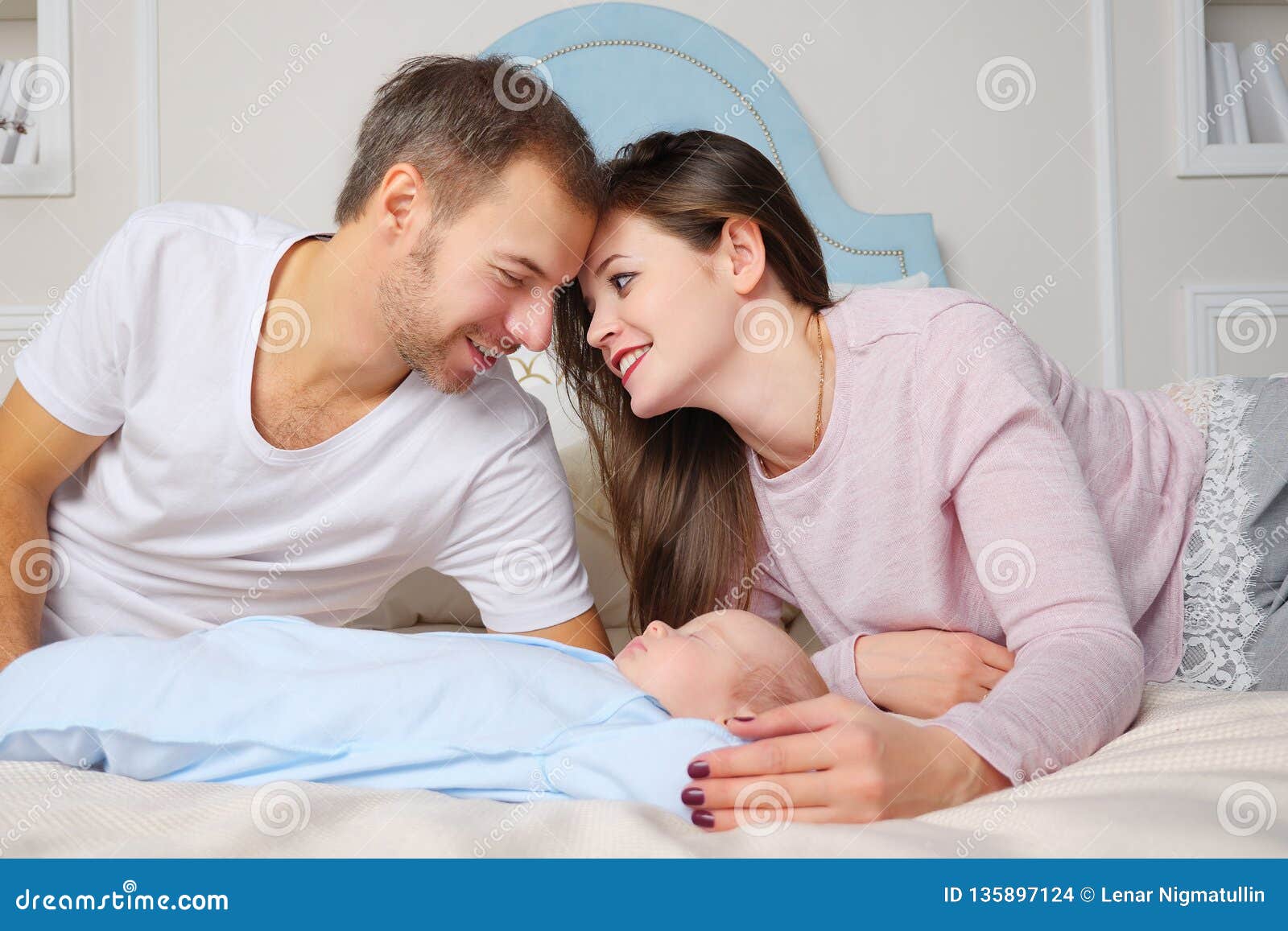 Happy Parents with Sleeping Baby Stock Photo - Image of cheerful