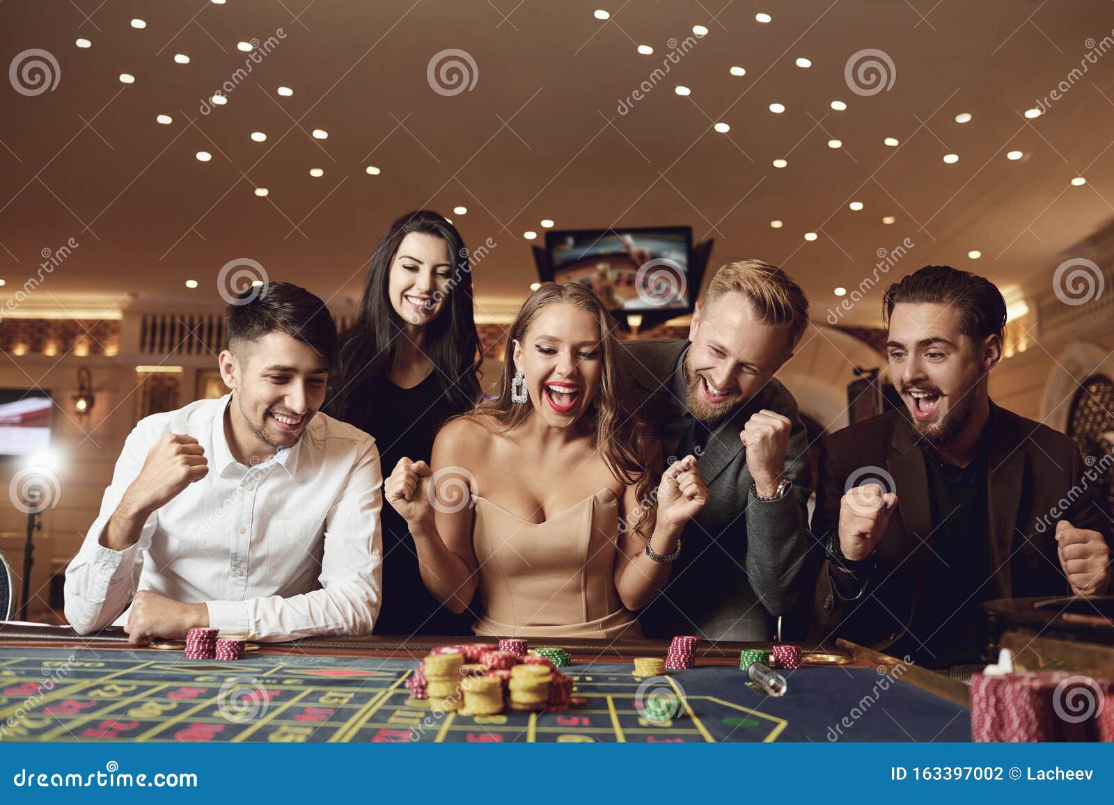 Happy People Are Betting In Gambling At Roulette Poker In A Casino ...