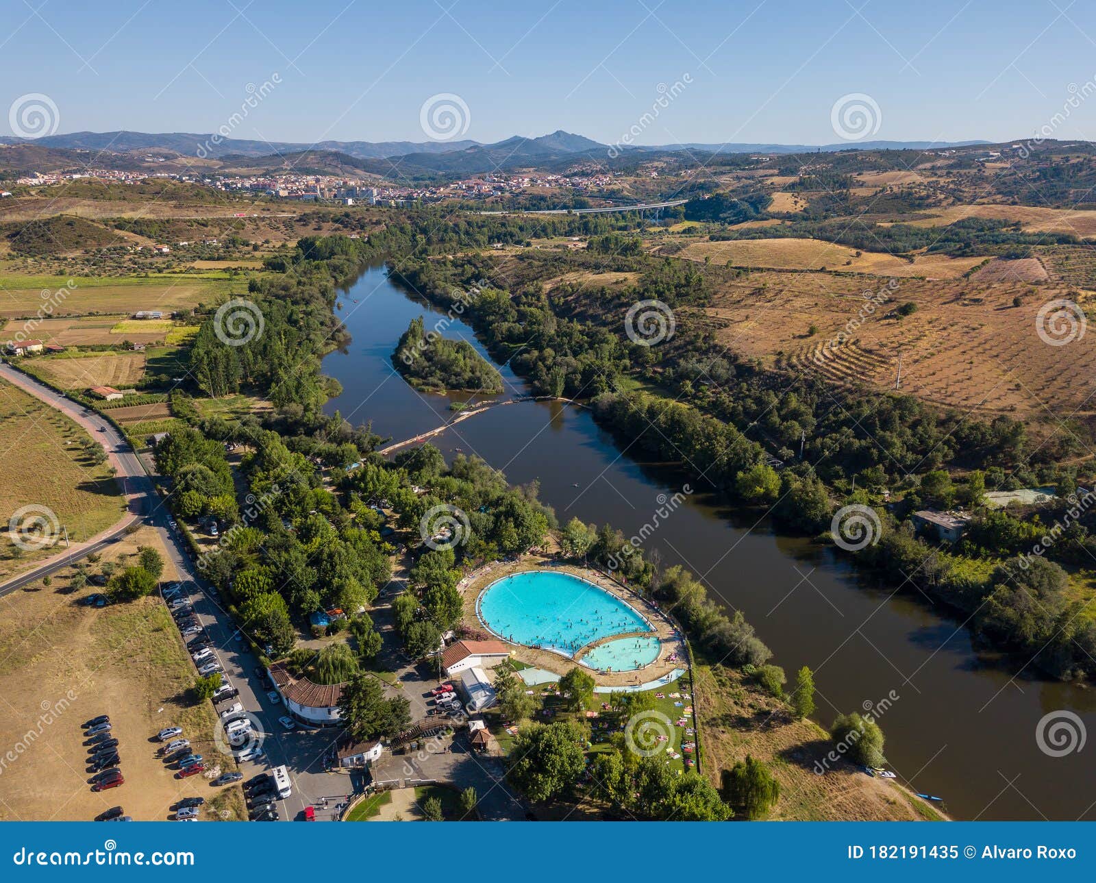 happy people swimming on vacation. aerial view over amazing pool. drone point of view in summer landscape. swimming pool in mirand