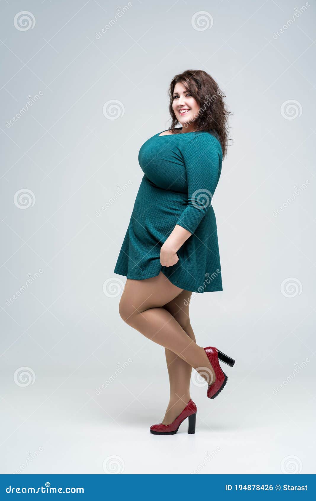 Happy Plus Size Fashion Model in Green Dress, Fat Woman on Gray ...