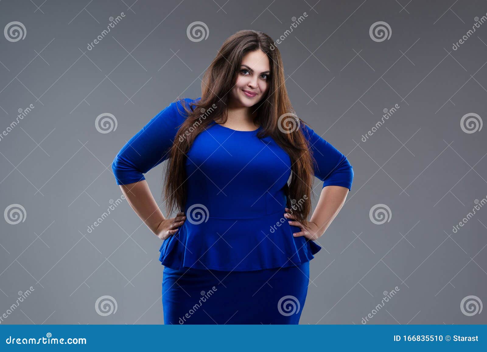 Happy Plus Size Model in Blue Dress, Fat Woman with Long Hair on Gray ...