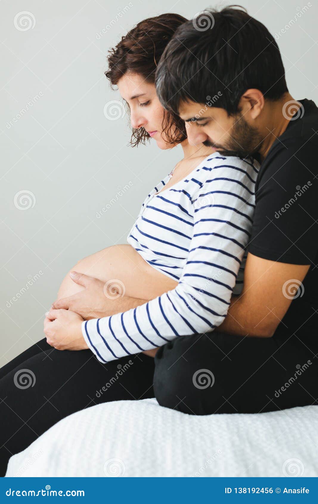 Loving Pregnant Couple Sitting on the Bed Stock Photo - Image of baby,  female: 138192456