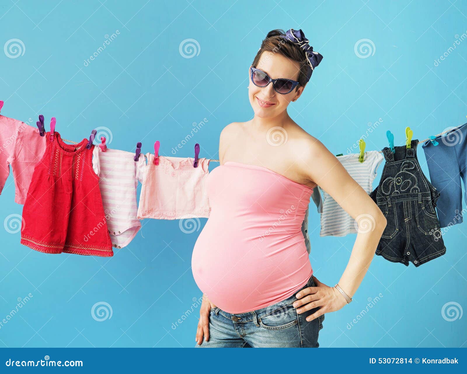 Happy pregnant mother doing the laundry