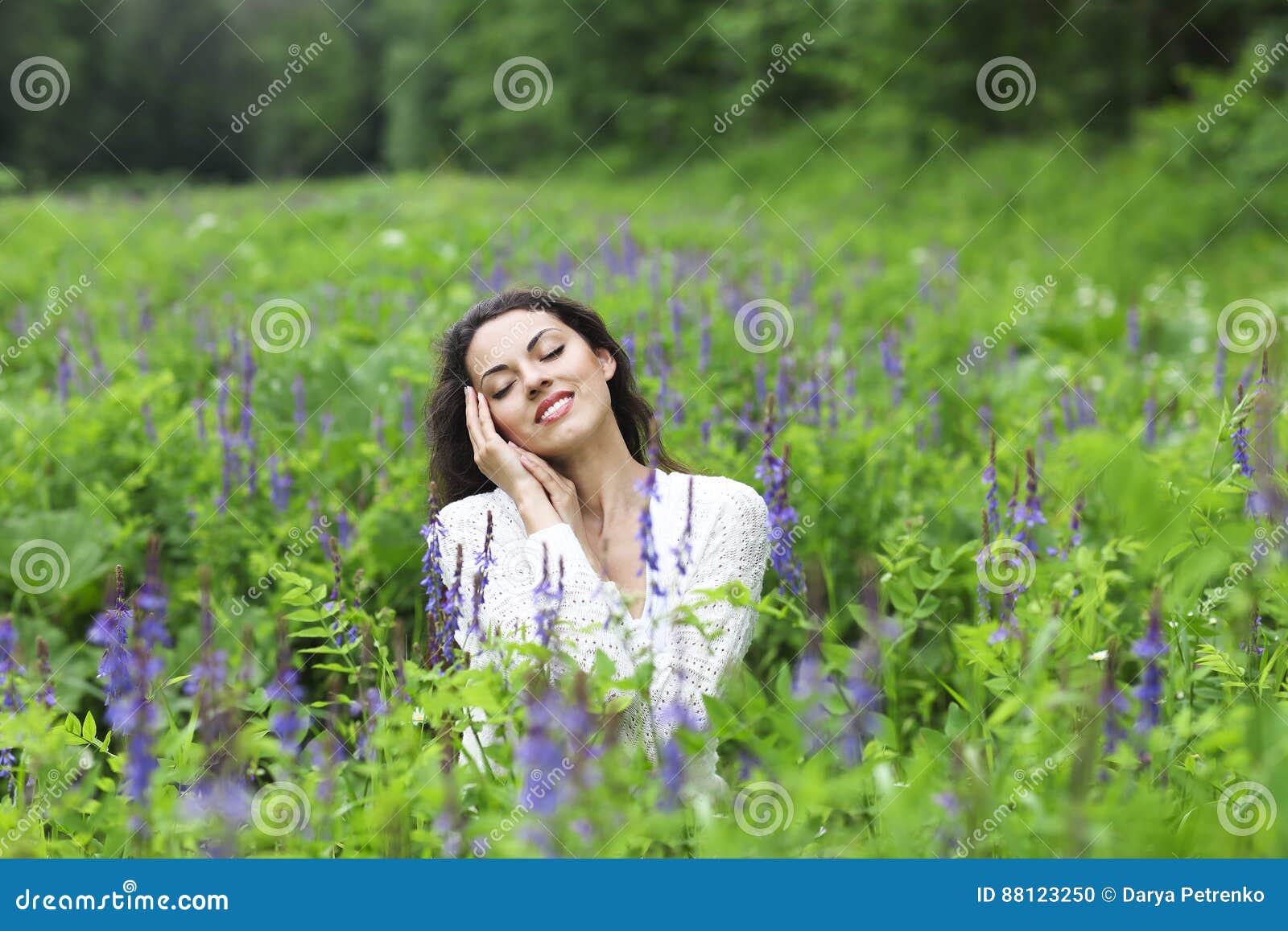 happy pretty brunette woman in flower field
