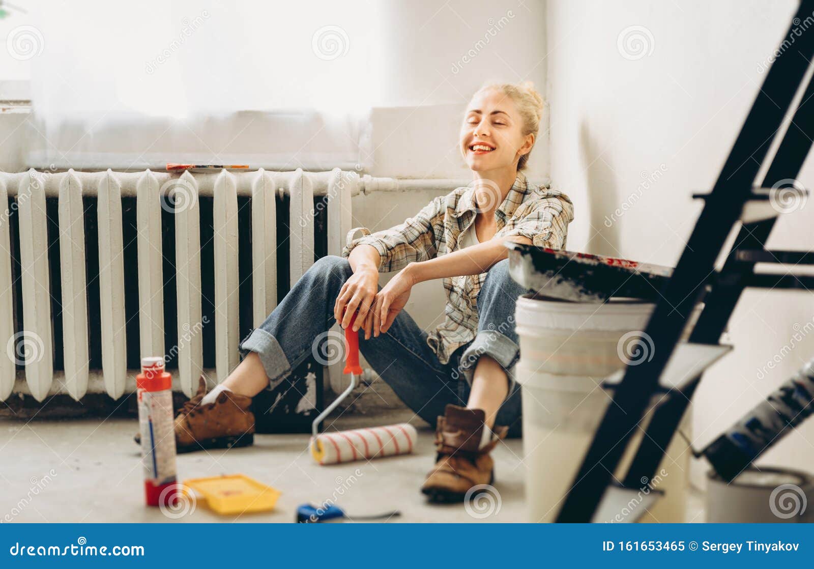 happy pretty young woman makes diy repairs in the house with her own hands. concept nontraditional gender roles, gender equality,