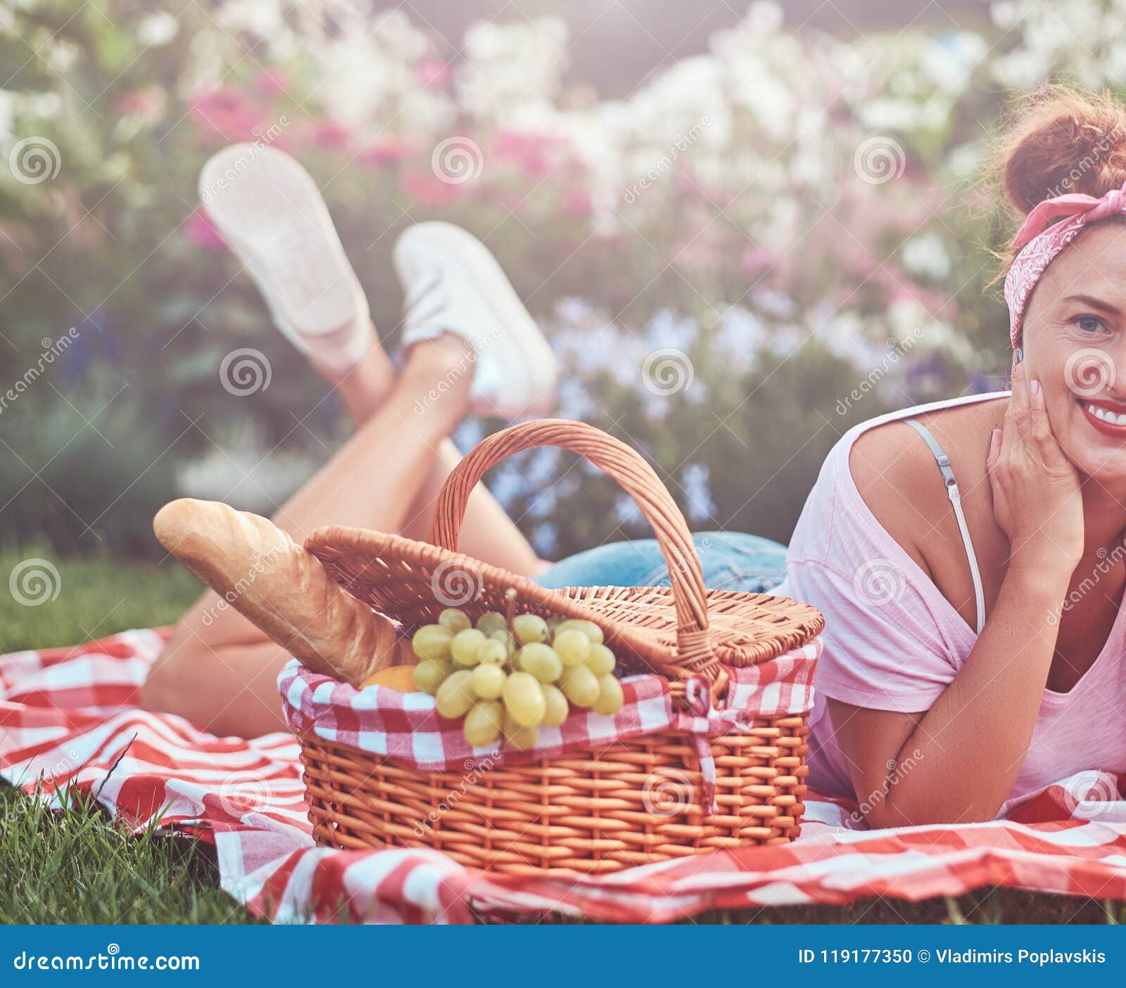 Happy Redhead Middle Age Female In Casual Clothes With A Headband Enjoying During Picnic