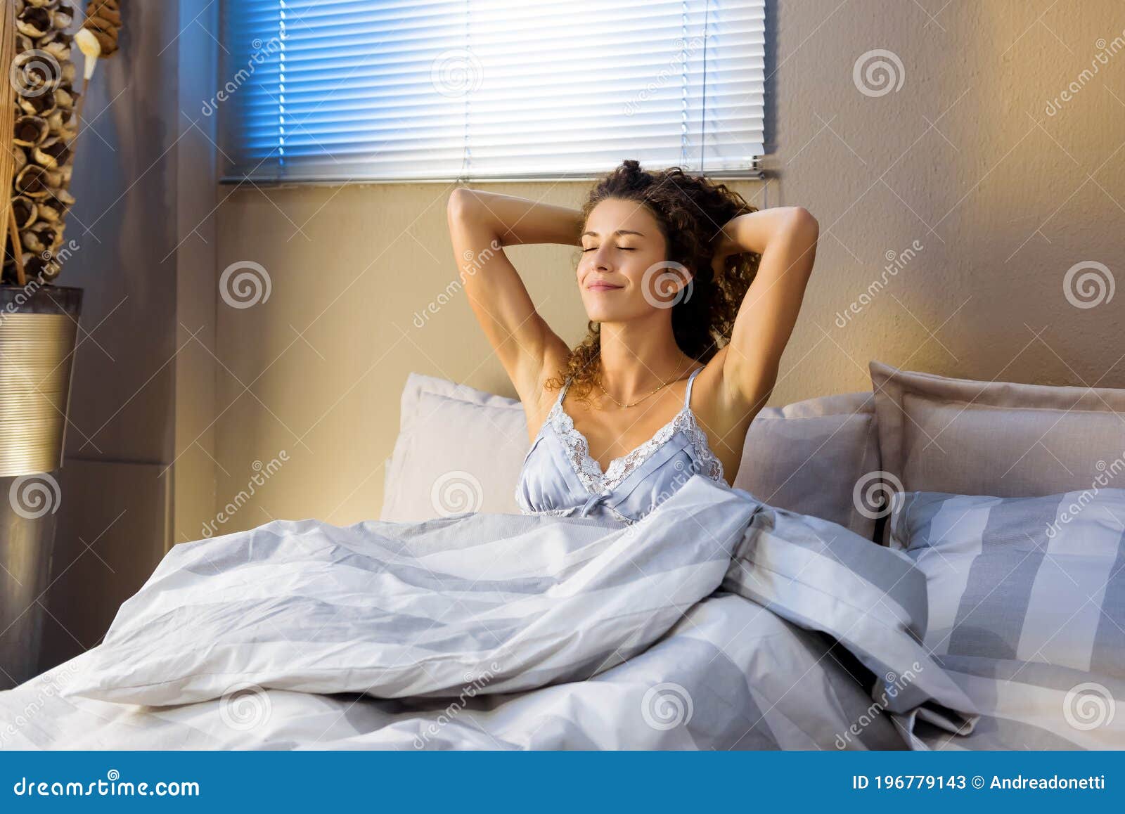 happy refreshed young woman waking from a sleep