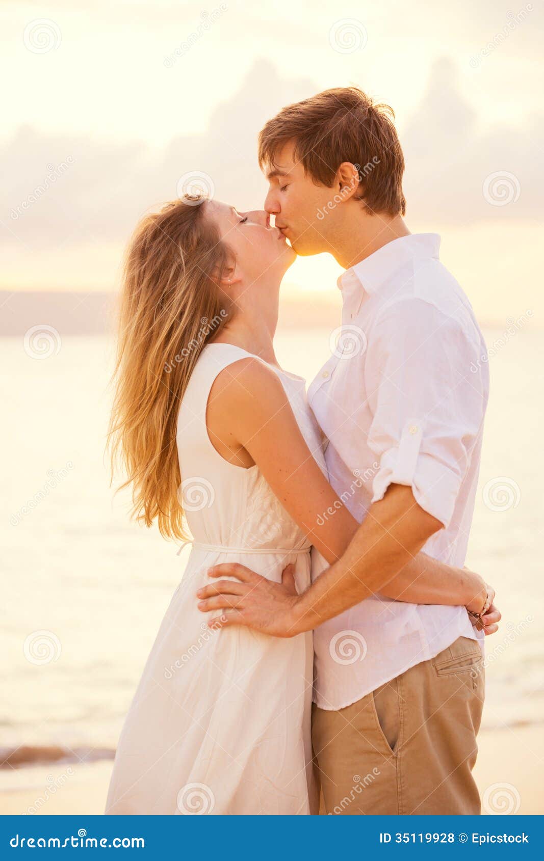 Happy Romantic Couple Kissing on the Beach at Sunset Stock Photo ...