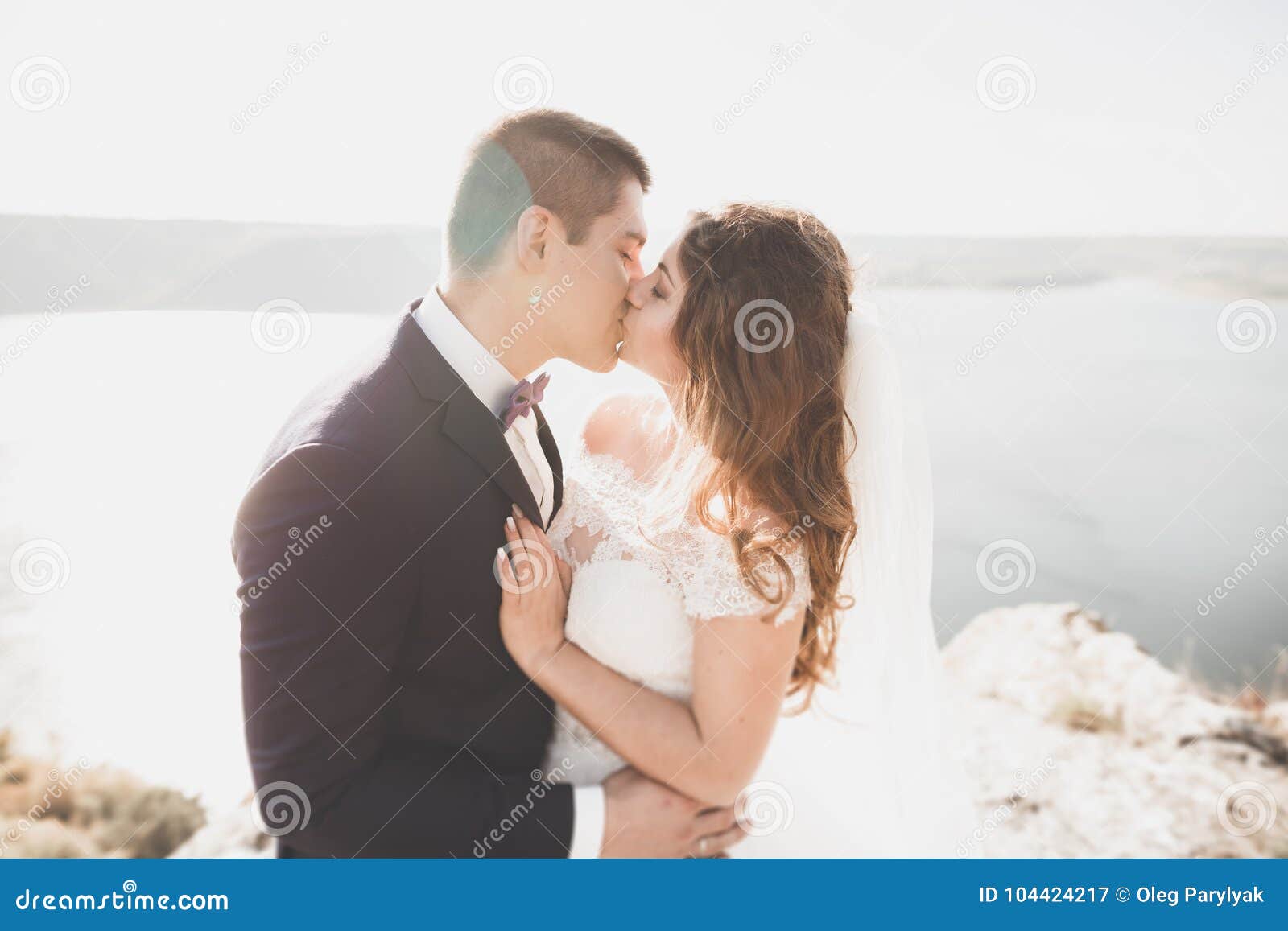Happy And Romantic Scene Of Just Married Young Wedding Couple Posing
