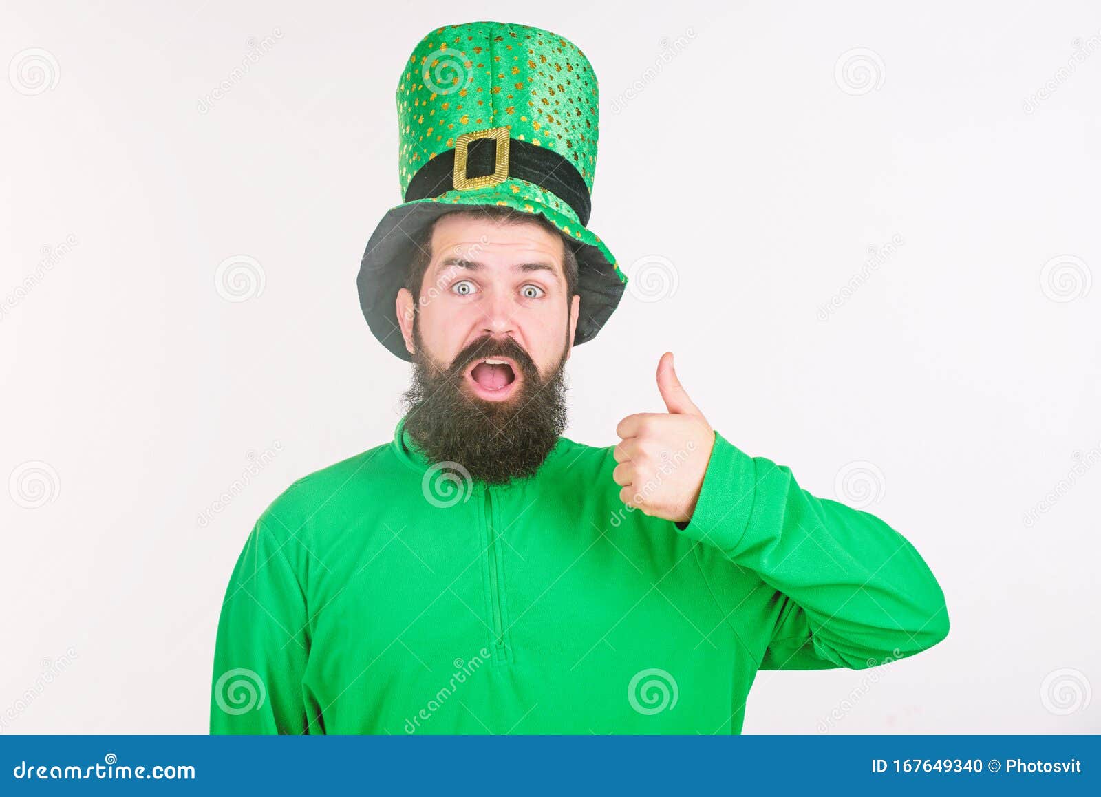 Happy saint patricks day. Hipster in leprechaun hat and costume keeping mouth open. Bearded man celebrating saint patricks day. Irish man with beard wearing green. Thumbs up for saint patrick.