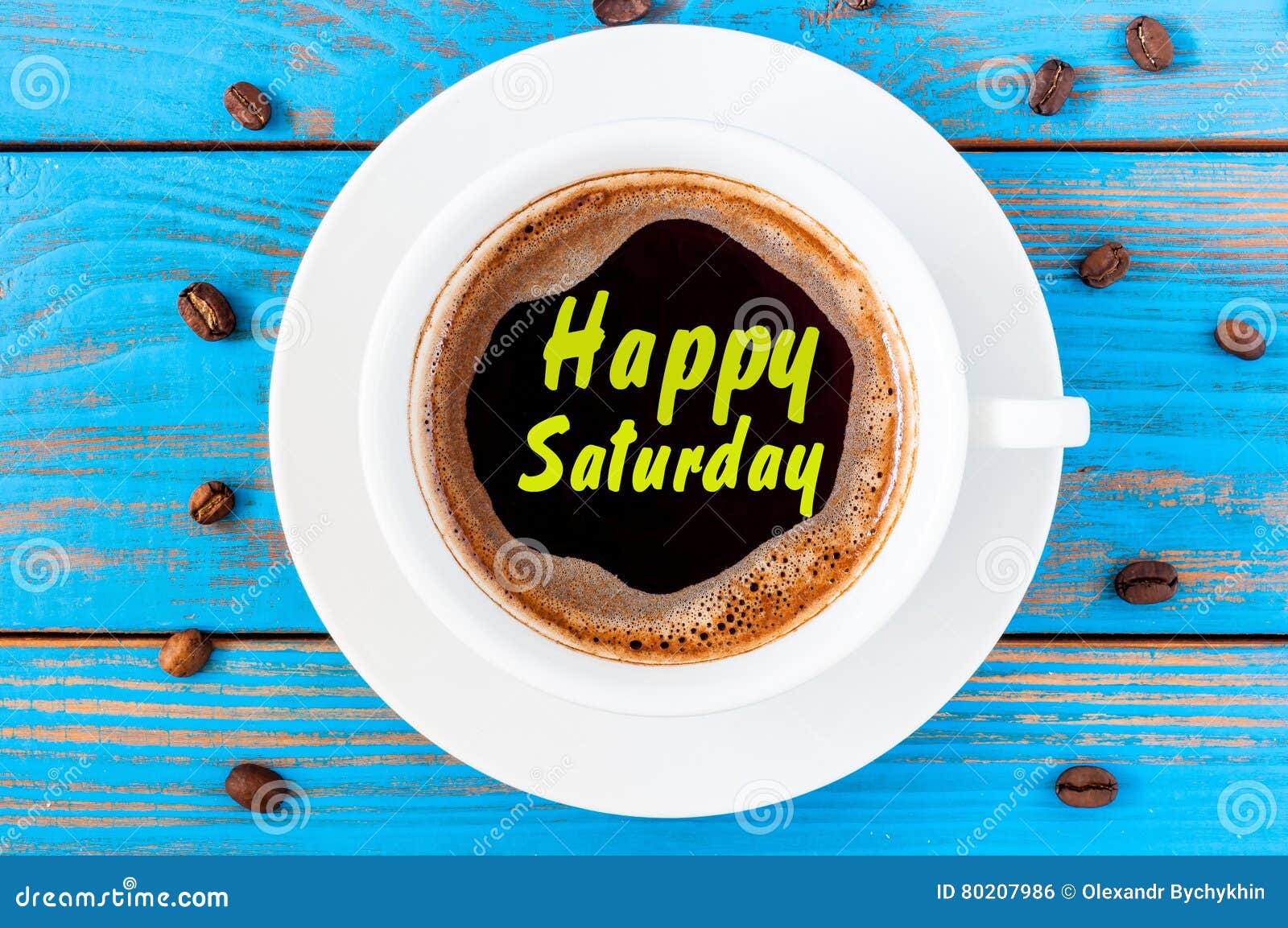 happy saturday written on coffee cup at blue wooden background with beans