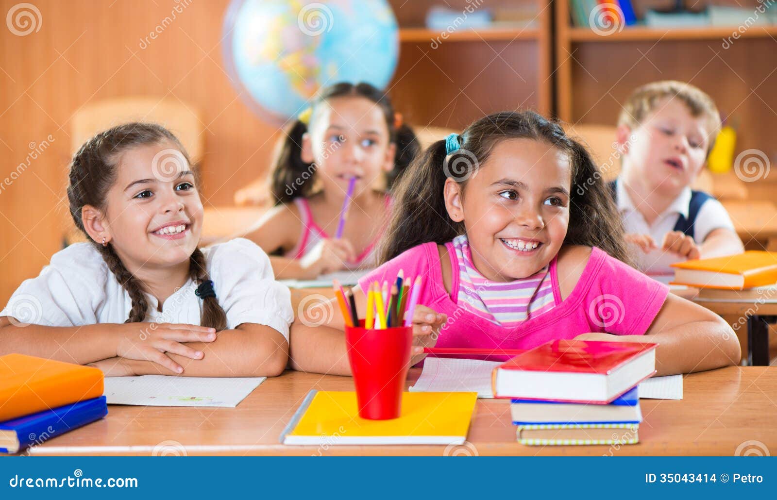 happy schoolchildren during lesson in classroom