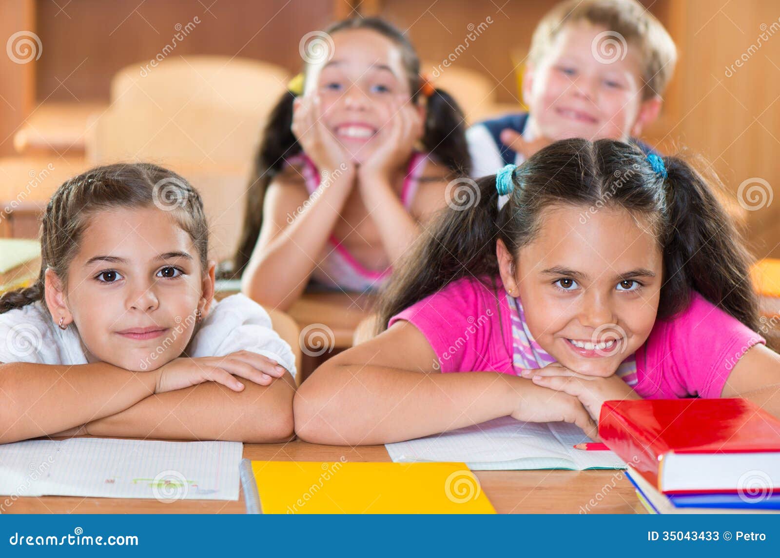 happy schoolchildren during lesson in classroom