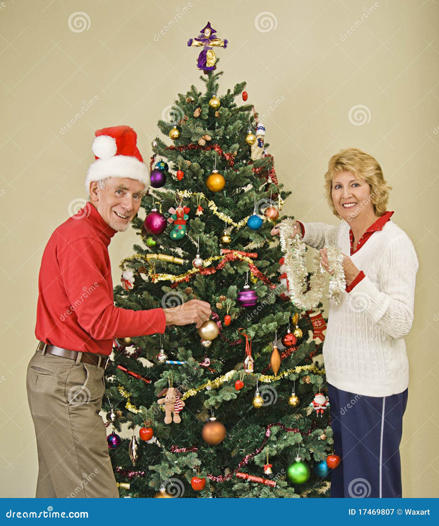 Happy Senior Couple Decorating Christmas Tree Royalty Free 