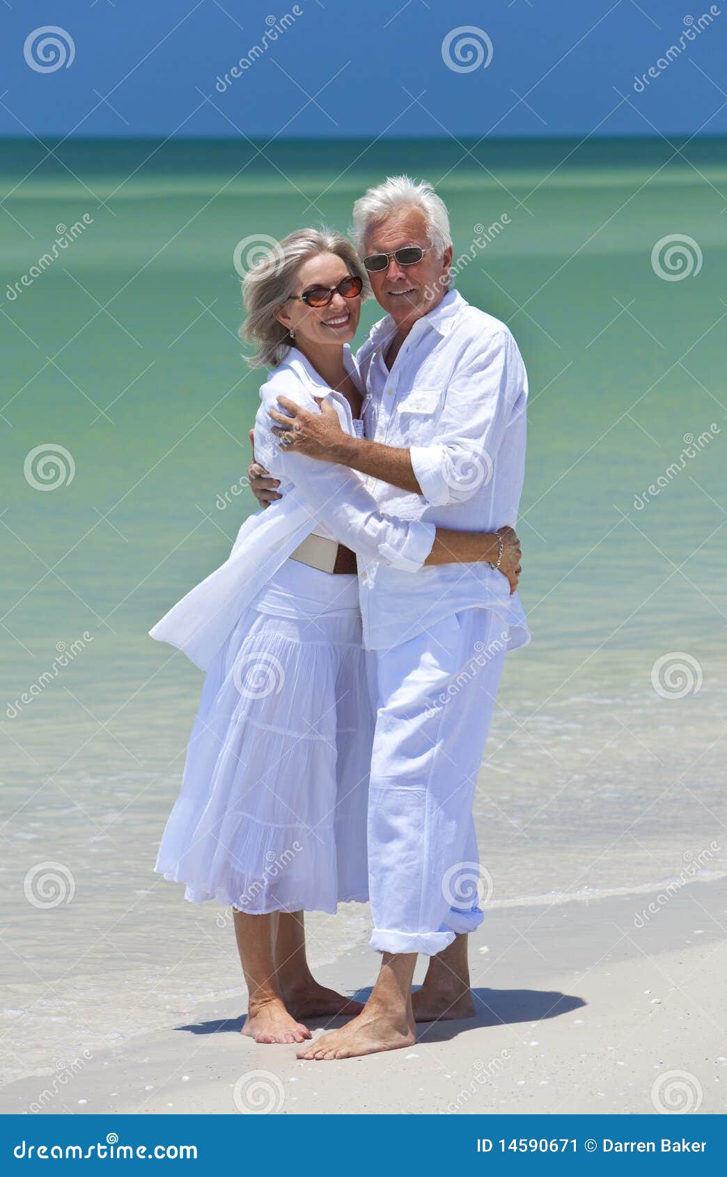 happy senior couple embracing on a tropical beach