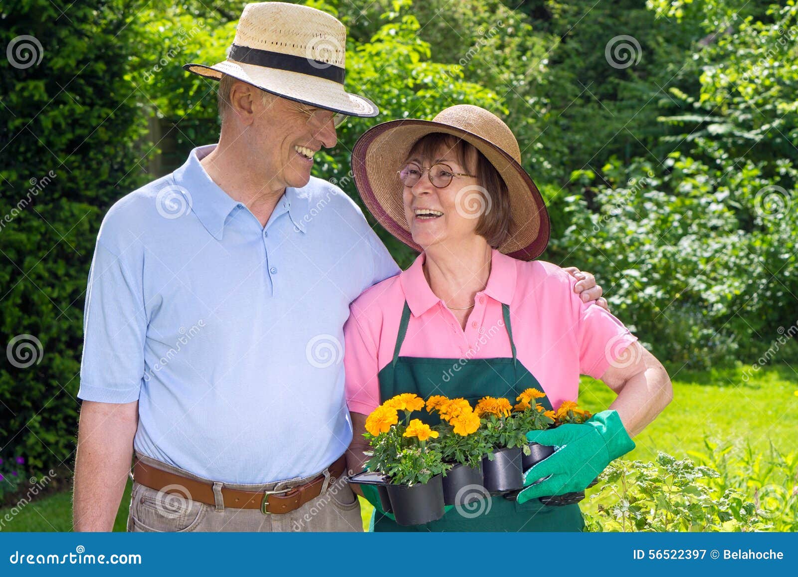 Happy Senior Couple in Garden with Flat of Flowers Stock Image - Image ...