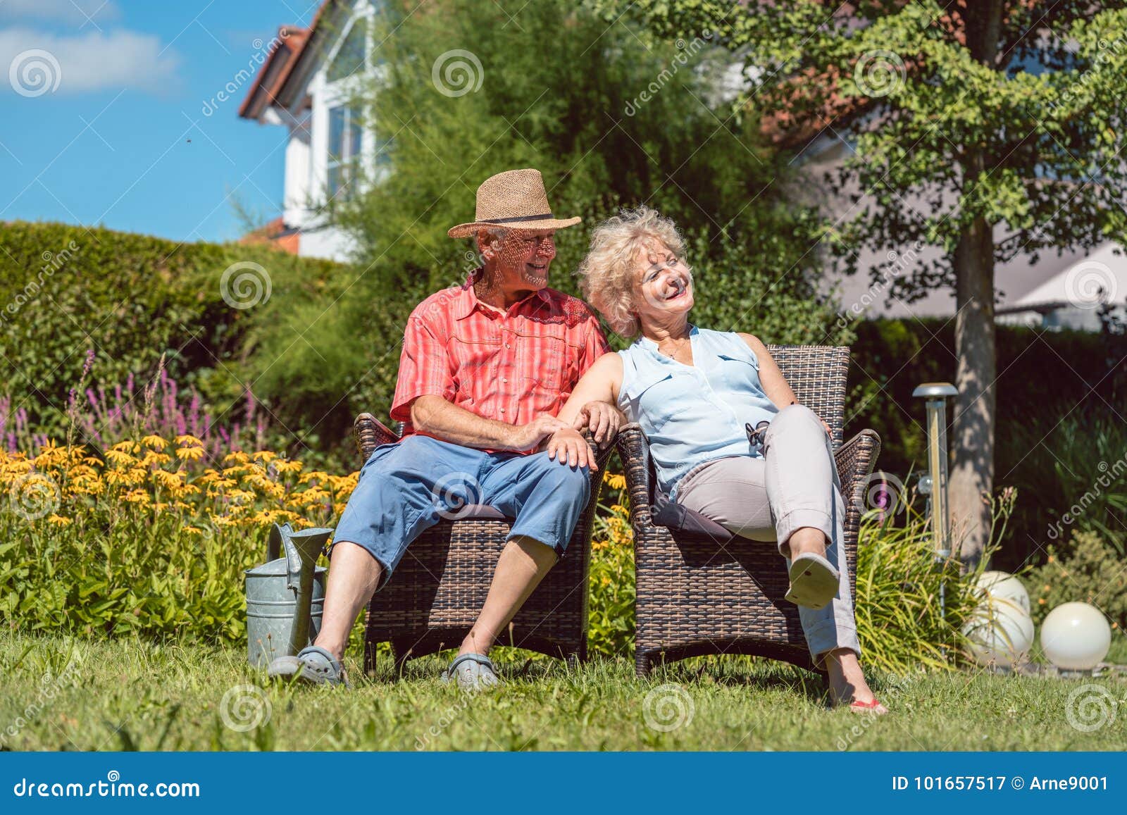 happy senior couple in love relaxing together in the garden in a