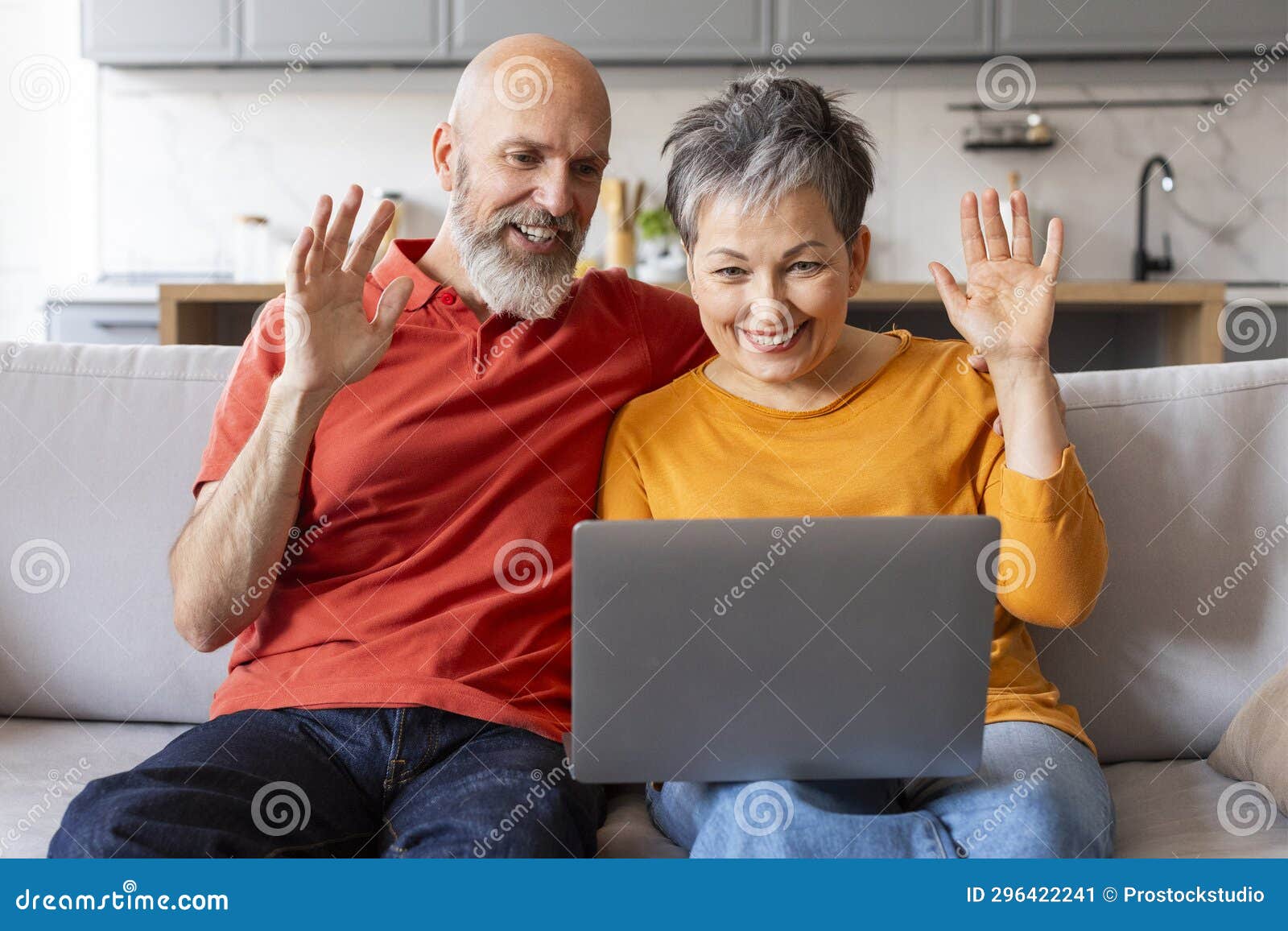 Happy Senior Couple Making Video Call With Laptop At Home Stock Image