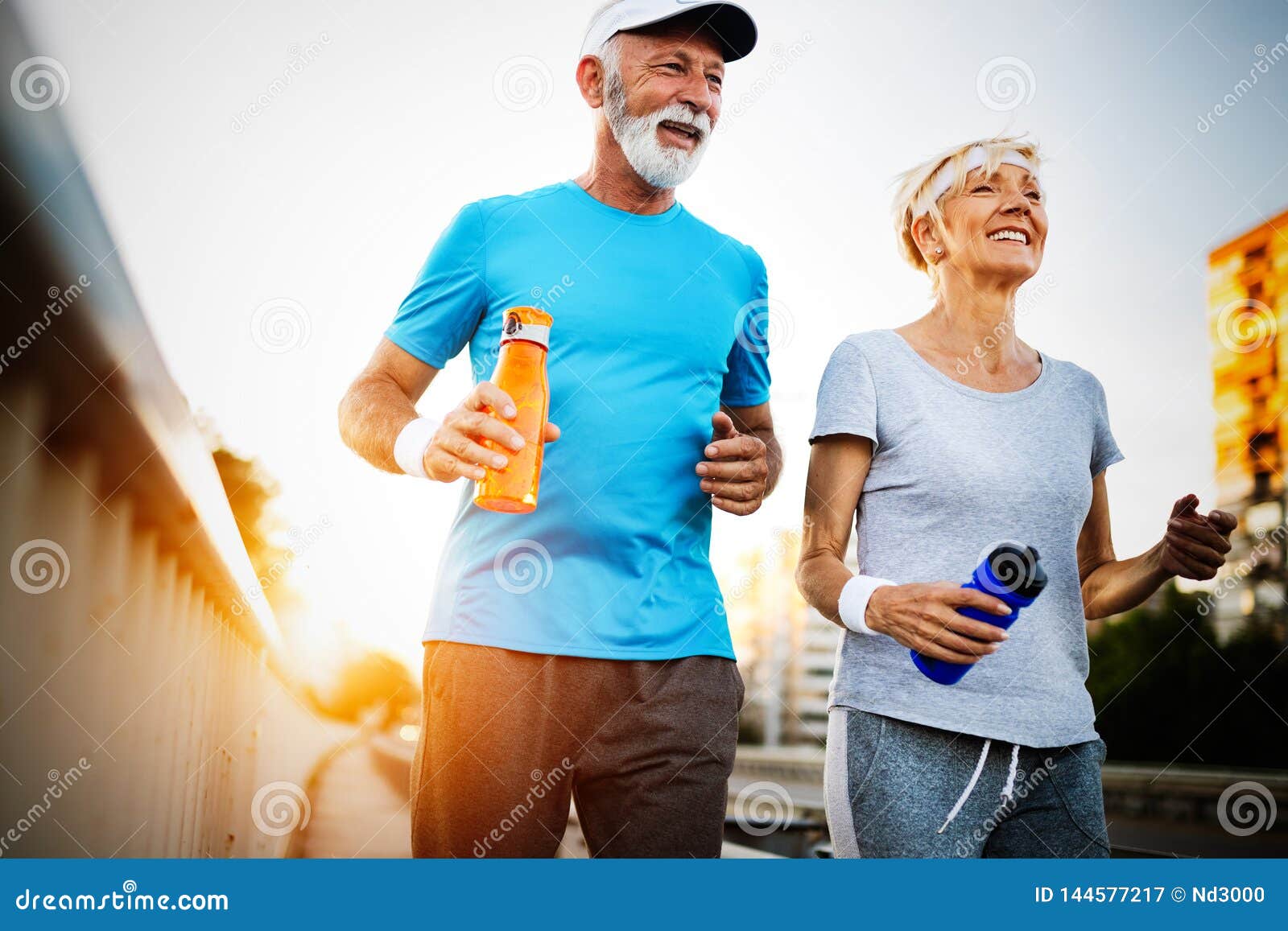 happy senior couple staying fit by sport running