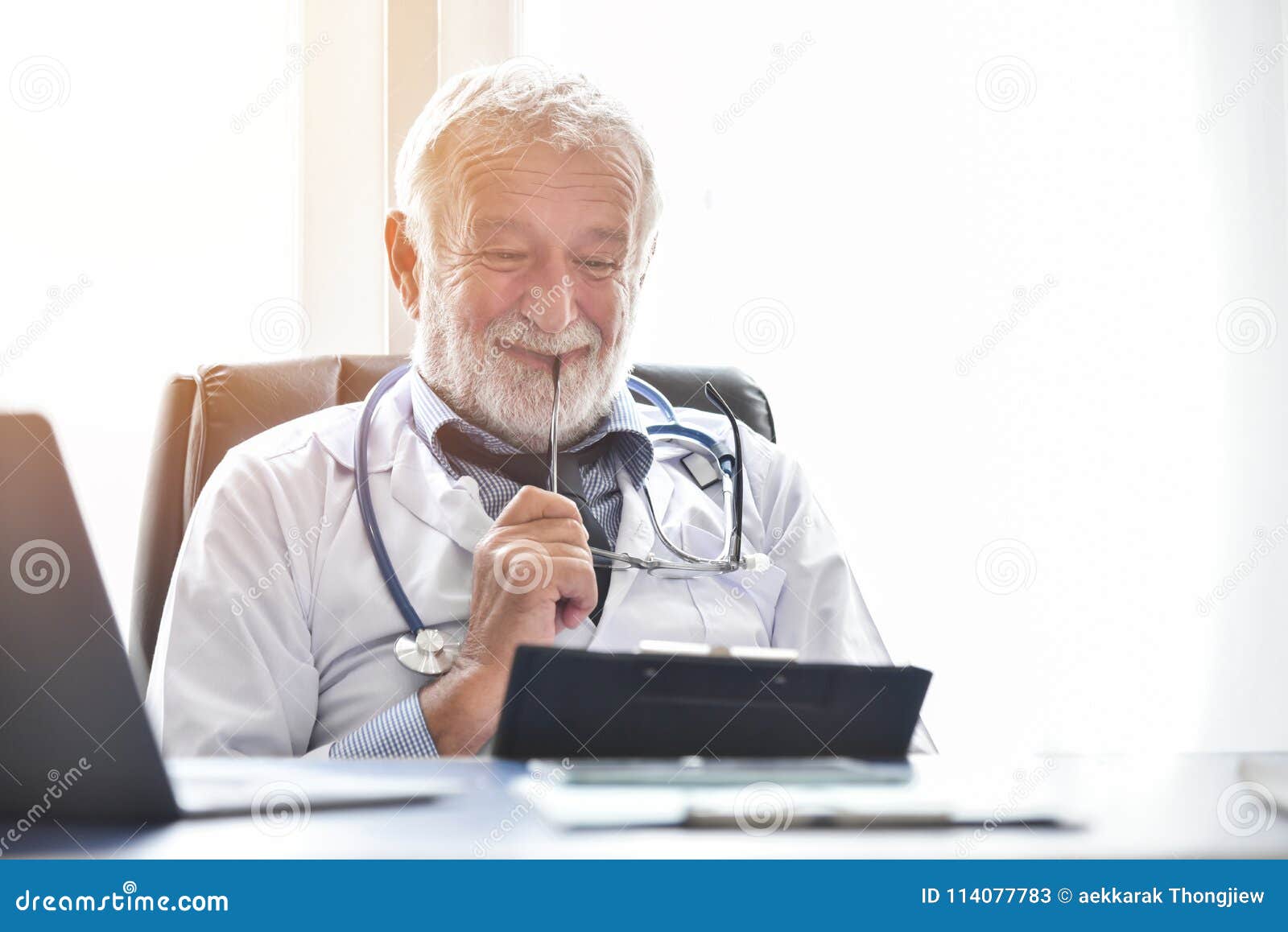 Happy Senior Male Doctor is Checking His Patient Medical Records Stock ...